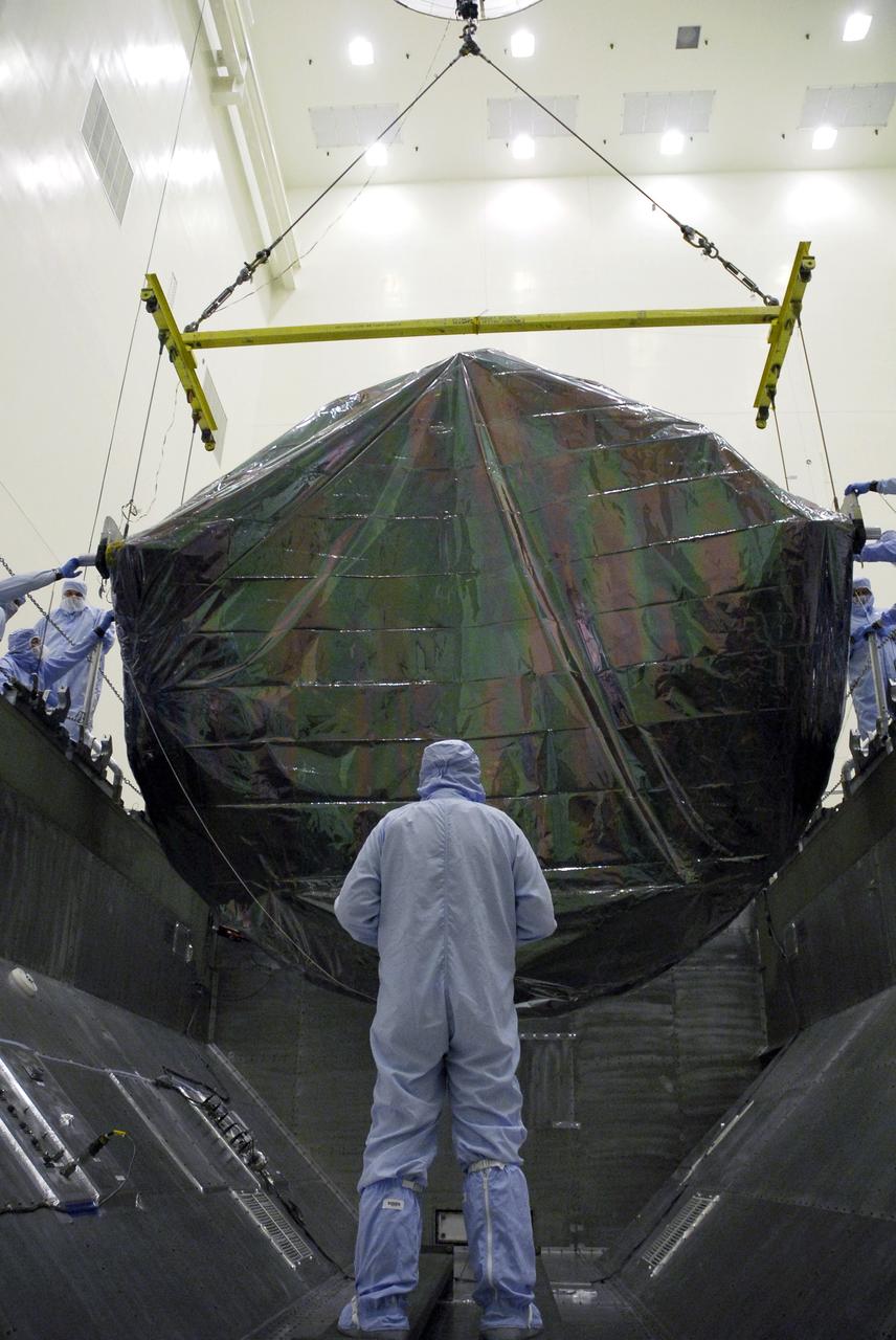 CAPE CANAVERAL, Fla. -  In the Payload Hazardous Servicing Facility at NASA’s Kennedy Space Center, workers monitor the movement of the Flight Support System carrier with the Soft Capture Mechanism as it is lowered into the payload canister.  The carrier is associated with the STS-125 mission to service the Hubble Space Telescope.  The canister will transfer the carrier to Launch Pad 39A.  The carrier is one of four associated with the STS-125 mission to service the Hubble Space Telescope.  At the pad, all the carriers will be loaded into space shuttle Atlantis’ payload bay.  Launch of Atlantis is targeted for Oct. 10. Photo credit: NASA/Cory Huston