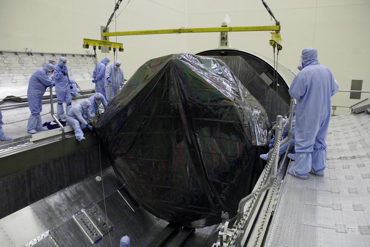 CAPE CANAVERAL, Fla. - In the Payload Hazardous Servicing Facility at NASA’s Kennedy Space Center, workers begin securing the Flight Support System carrier with the Soft Capture Mechanism in the payload canister. The canister will transfer the carrier to Launch Pad 39A. The carrier is one of four associated with the STS-125 mission to service the Hubble Space Telescope. At the pad, all the carriers will be loaded into space shuttle Atlantis’ payload bay. Launch of Atlantis is targeted for Oct. 10. Photo credit: NASA/Cory Huston