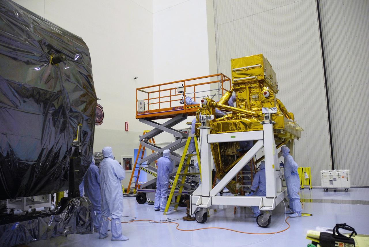 CAPE CANAVERAL, Fla. - In the Payload Hazardous Servicing Facility at NASA's Kennedy Space Center, technicians inspect areas of the Super Lightweight Interchangeable Carrier, or SLIC, for contamination. Contamination discovered Sept. 17 during preparations to deliver NASA's Hubble Space Telescope servicing payload to Launch Pad 39A will be removed. Cleanliness is extremely important for space shuttle Atlantis’ STS-125 mission to Hubble, and the teams have insured that the SLIC is ready to fly. The SLIC, which holds battery module assemblies for servicing of the Hubble Space Telescope on the STS-125 mission, is built with state-of-the-art, lightweight, composite materials - carbon fiber with a cyanate ester resin and a titanium metal matrix composite. These composites have greater strength-to-mass ratios than the metals typically used in spacecraft design. The carrier is one of four being transferred to Launch Pad 39A. At the pad, the carriers will be loaded into Atlantis’ payload bay. Launch of Atlantis is targeted for Oct. 10. Photo credit: NASA/Jack Pfaller