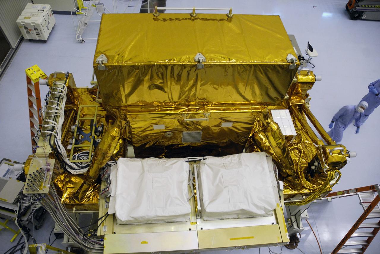 CAPE CANAVERAL, Fla. - In the Payload Hazardous Servicing Facility at NASA's Kennedy Space Center, the Super Lightweight Interchangeable Carrier, or SLIC, is uncovered so that technicians can clean contaminants found earlier. Contamination discovered Sept. 17 during preparations to deliver NASA's Hubble Space Telescope servicing payload to Launch Pad 39A will be removed. Cleanliness is extremely important for space shuttle Atlantis’ STS-125 mission to Hubble, and the teams have insured that the SLIC is ready to fly. The SLIC, which holds battery module assemblies, is built with state-of-the-art, lightweight, composite materials - carbon fiber with a cyanate ester resin and a titanium metal matrix composite. These composites have greater strength-to-mass ratios than the metals typically used in spacecraft design. The carrier is one of four being transferred to Launch Pad 39A. At the pad, the carriers will be loaded into Atlantis’ payload bay. Launch of Atlantis is targeted for Oct. 10. Photo credit: NASA/Jack Pfaller