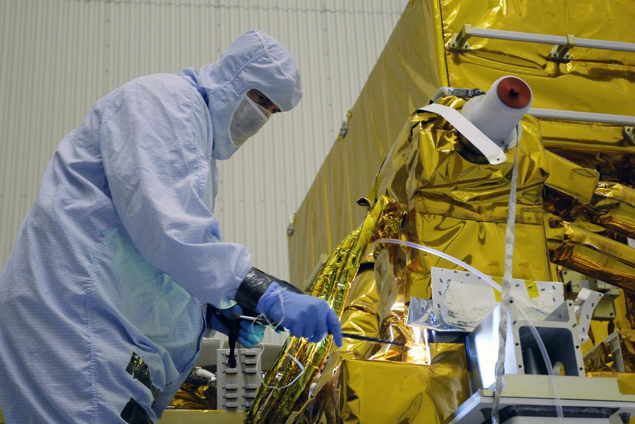 CAPE CANAVERAL, Fla. - In the Payload Hazardous Servicing Facility at NASA's Kennedy Space Center, a technician cleans contamination from the Super Lightweight Interchangeable Carrier, or SLIC. Contamination discovered Sept. 17 during preparations to deliver NASA's Hubble Space Telescope servicing payload to Launch Pad 39A. Cleanliness is extremely important for space shuttle Atlantis’ STS-125 mission to Hubble, and the teams have insured that the SLIC is ready to fly. The SLIC, which holds battery module assemblies, is built with state-of-the-art, lightweight, composite materials - carbon fiber with a cyanate ester resin and a titanium metal matrix composite. These composites have greater strength-to-mass ratios than the metals typically used in spacecraft design. The carrier is one of four being transferred to Launch Pad 39A. At the pad, the carriers will be loaded into Atlantis’ payload bay. Launch of Atlantis is targeted for Oct. 10. Photo credit: NASA/Jack Pfaller
