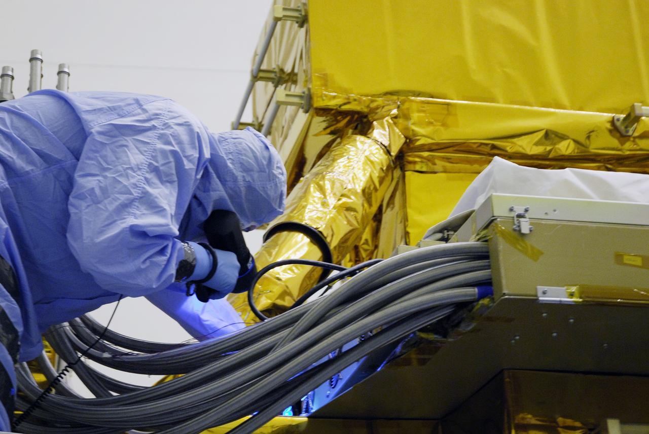 CAPE CANAVERAL, Fla. - In the Payload Hazardous Servicing Facility at NASA's Kennedy Space Center, a technician cleans contamination from the Super Lightweight Interchangeable Carrier, or SLIC. Contamination discovered Sept. 17 during preparations to deliver NASA's Hubble Space Telescope servicing payload to Launch Pad 39A. Cleanliness is extremely important for space shuttle Atlantis’ STS-125 mission to Hubble, and the teams have insured that the SLIC is ready to fly. The SLIC, which holds battery module assemblies, is built with state-of-the-art, lightweight, composite materials - carbon fiber with a cyanate ester resin and a titanium metal matrix composite. These composites have greater strength-to-mass ratios than the metals typically used in spacecraft design. The carrier is one of four being transferred to Launch Pad 39A. At the pad, the carriers will be loaded into Atlantis’ payload bay. Launch of Atlantis is targeted for Oct. 10. Photo credit: NASA/Jack Pfaller