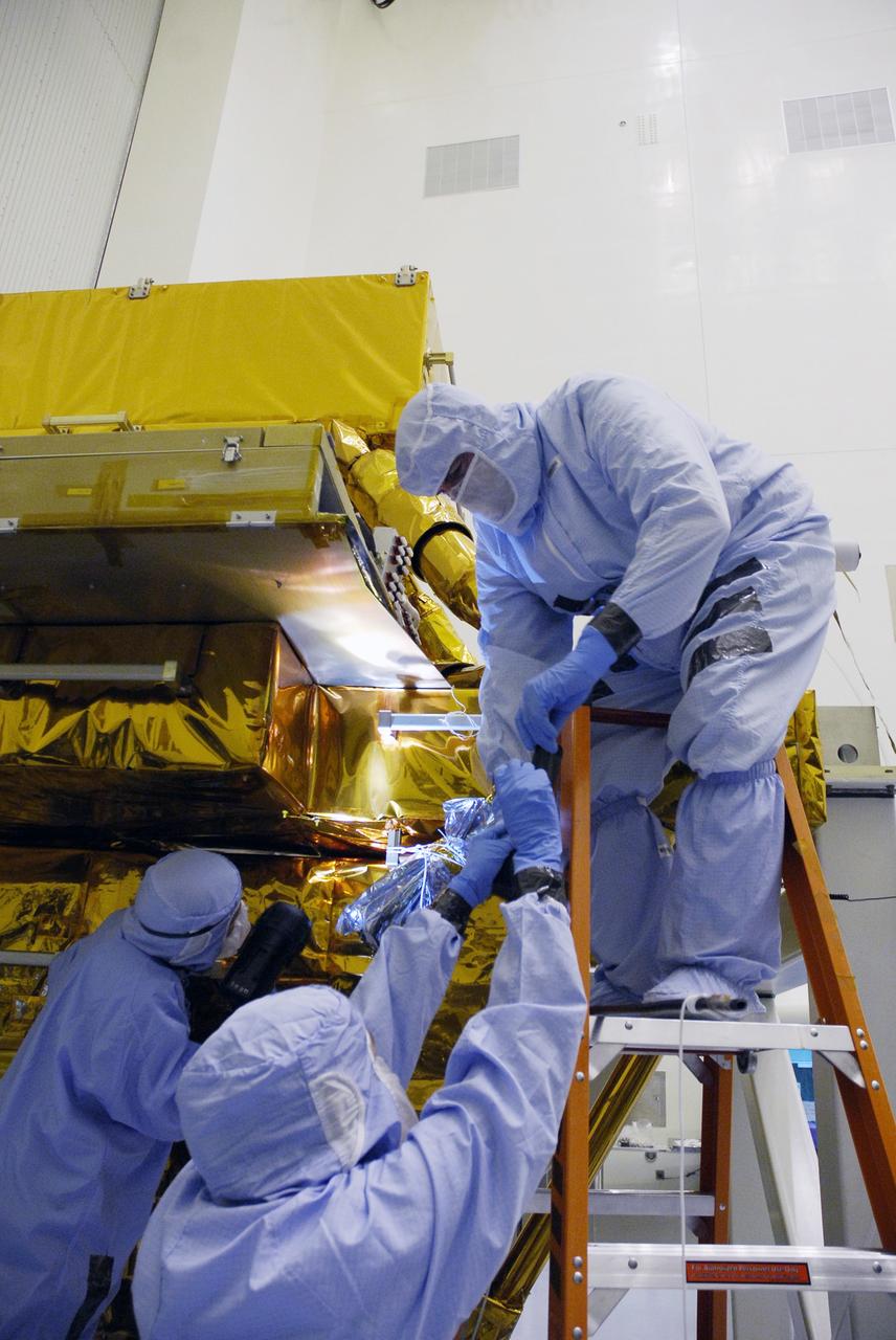 CAPE CANAVERAL, Fla. - In the Payload Hazardous Servicing Facility at NASA's Kennedy Space Center, technicians clean contamination from the Super Lightweight Interchangeable Carrier, or SLIC. Contamination discovered Sept. 17 during preparations to deliver NASA's Hubble Space Telescope servicing payload to Launch Pad 39A. Cleanliness is extremely important for space shuttle Atlantis’ STS-125 mission to Hubble, and the teams have insured that the SLIC is ready to fly. The SLIC, which holds battery module assemblies, is built with state-of-the-art, lightweight, composite materials - carbon fiber with a cyanate ester resin and a titanium metal matrix composite. These composites have greater strength-to-mass ratios than the metals typically used in spacecraft design. The carrier is one of four being transferred to Launch Pad 39A. At the pad, the carriers will be loaded into Atlantis’ payload bay. Launch of Atlantis is targeted for Oct. 10. Photo credit: NASA/Jack Pfaller