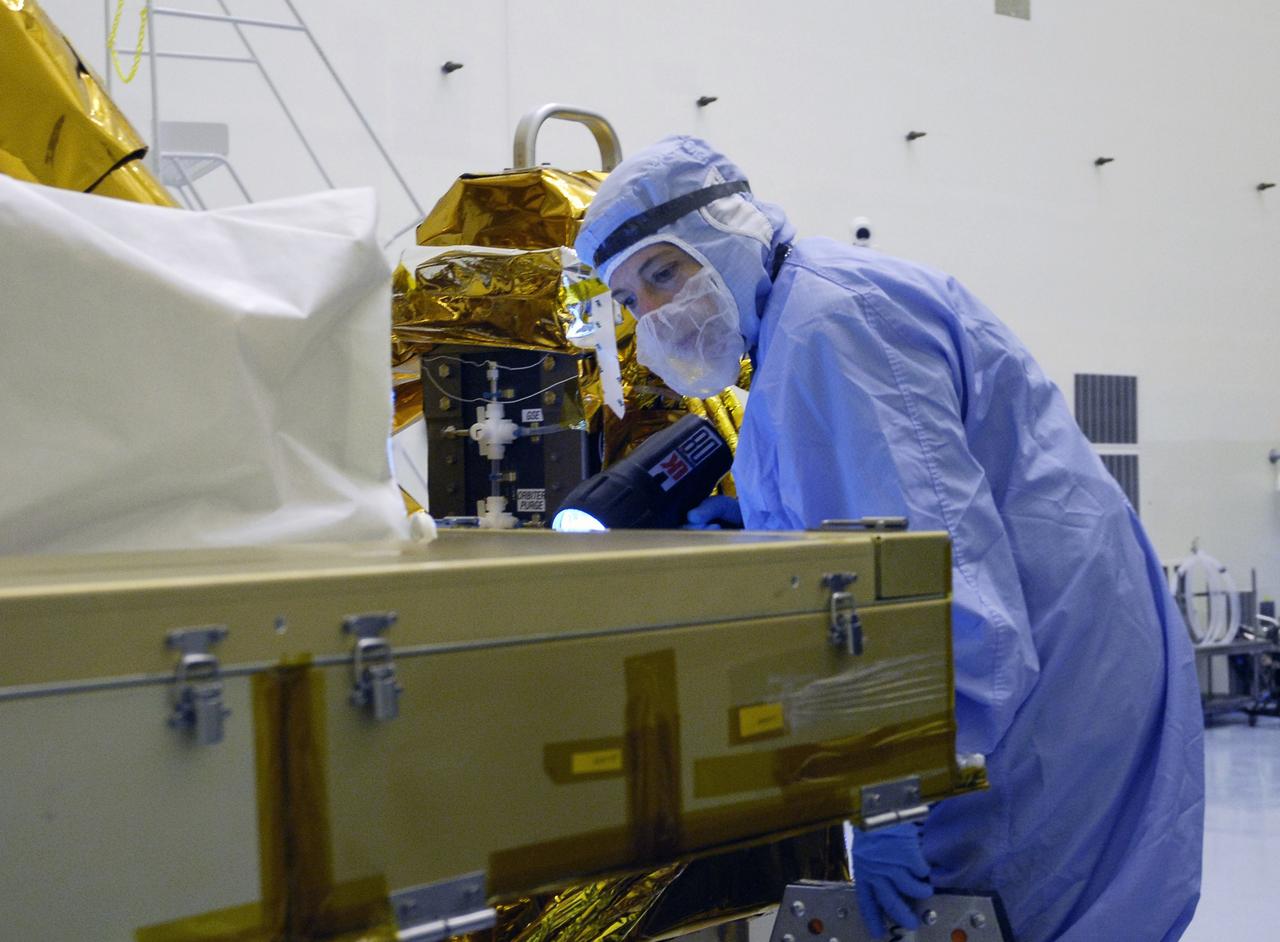 CAPE CANAVERAL, Fla. - In the Payload Hazardous Servicing Facility at NASA's Kennedy Space Center, a technician cleans contamination from the Super Lightweight Interchangeable Carrier, or SLIC. Contamination discovered Sept. 17 during preparations to deliver NASA's Hubble Space Telescope servicing payload to Launch Pad 39A. Cleanliness is extremely important for space shuttle Atlantis’ STS-125 mission to Hubble, and the teams have insured that the SLIC is ready to fly. The SLIC, which holds battery module assemblies, is built with state-of-the-art, lightweight, composite materials - carbon fiber with a cyanate ester resin and a titanium metal matrix composite. These composites have greater strength-to-mass ratios than the metals typically used in spacecraft design. The carrier is one of four being transferred to Launch Pad 39A. At the pad, the carriers will be loaded into Atlantis’ payload bay. Launch of Atlantis is targeted for Oct. 10. Photo credit: NASA/Jack Pfaller
