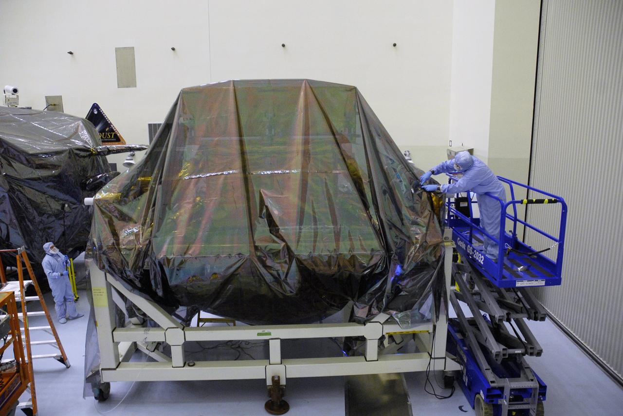 CAPE CANAVERAL, Fla. - In the Payload Hazardous Servicing Facility at NASA's Kennedy Space Center, technicians finish replacing the protective cover over the Super Lightweight Interchangeable Carrier, or SLIC. The cover was removed to clean the carrier of contaminants found Sept. 17 during preparations to deliver NASA's Hubble Space Telescope servicing payload to Launch Pad 39A. Cleanliness is extremely important for space shuttle Atlantis’ STS-125 mission to Hubble, and the teams have insured that the SLIC is ready to fly. The SLIC, which holds battery module assemblies, is built with state-of-the-art, lightweight, composite materials - carbon fiber with a cyanate ester resin and a titanium metal matrix composite. These composites have greater strength-to-mass ratios than the metals typically used in spacecraft design. The carrier is one of four being transferred to Launch Pad 39A. At the pad, the carriers will be loaded into Atlantis’ payload bay. Launch of Atlantis is targeted for Oct. 10. Photo credit: NASA/Jack Pfaller