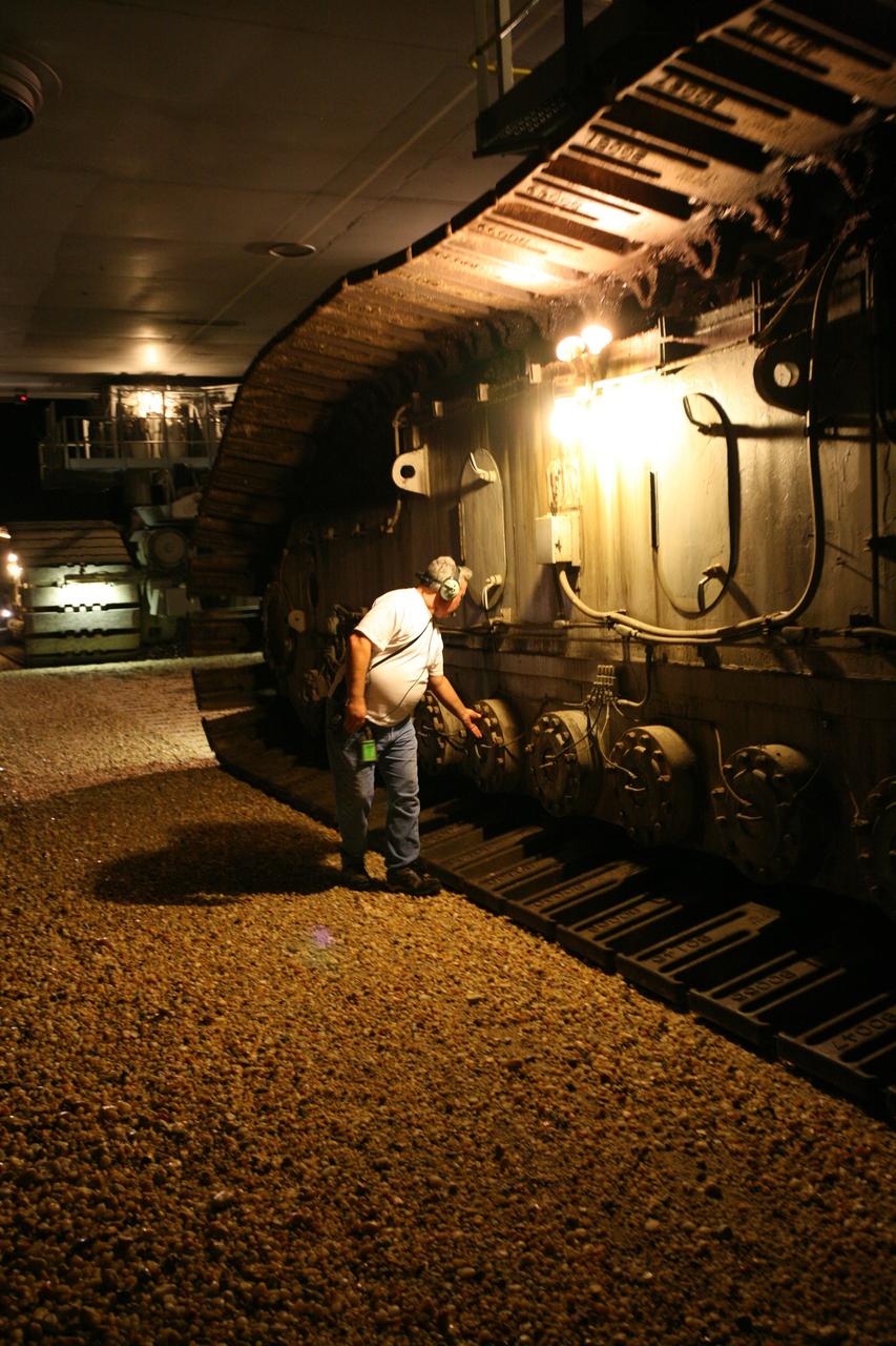 CAPE CANAVERAL, Fla. - During space shuttle Endeavour’s rollout to the launch pad at NASA's Kennedy Space Center, a worker checks equipment on the tracks of the massive crawler-transporter. The crawler travels on eight tracked tread belts, each containing 57 tread belt “shoes.” Each shoe is 7.5 feet long, 1.5 feet wide and weighs approximately 2,100 pounds. First motion of Endeavour from the Vehicle Assembly Building was at 11:15 p.m. Sept. 18. Endeavour completed the 4.2-mile journey to Launch Pad 39B on Sept. 19 at 6:59 a.m. EDT. For the first time since July 2001, two shuttles are on the launch pads at the same time at the center. Endeavour will stand by at pad B in the unlikely event that a rescue mission is necessary during space shuttle Atlantis' upcoming mission to repair NASA's Hubble Space Telescope, targeted to launch Oct. 10. After Endeavour is cleared from its duty as a rescue spacecraft, it will be moved to Launch Pad 39A for the STS-126 mission to the International Space Station. That flight is targeted for launch Nov. 12. Photo credit: NASA/Dimitri Gerondidakis