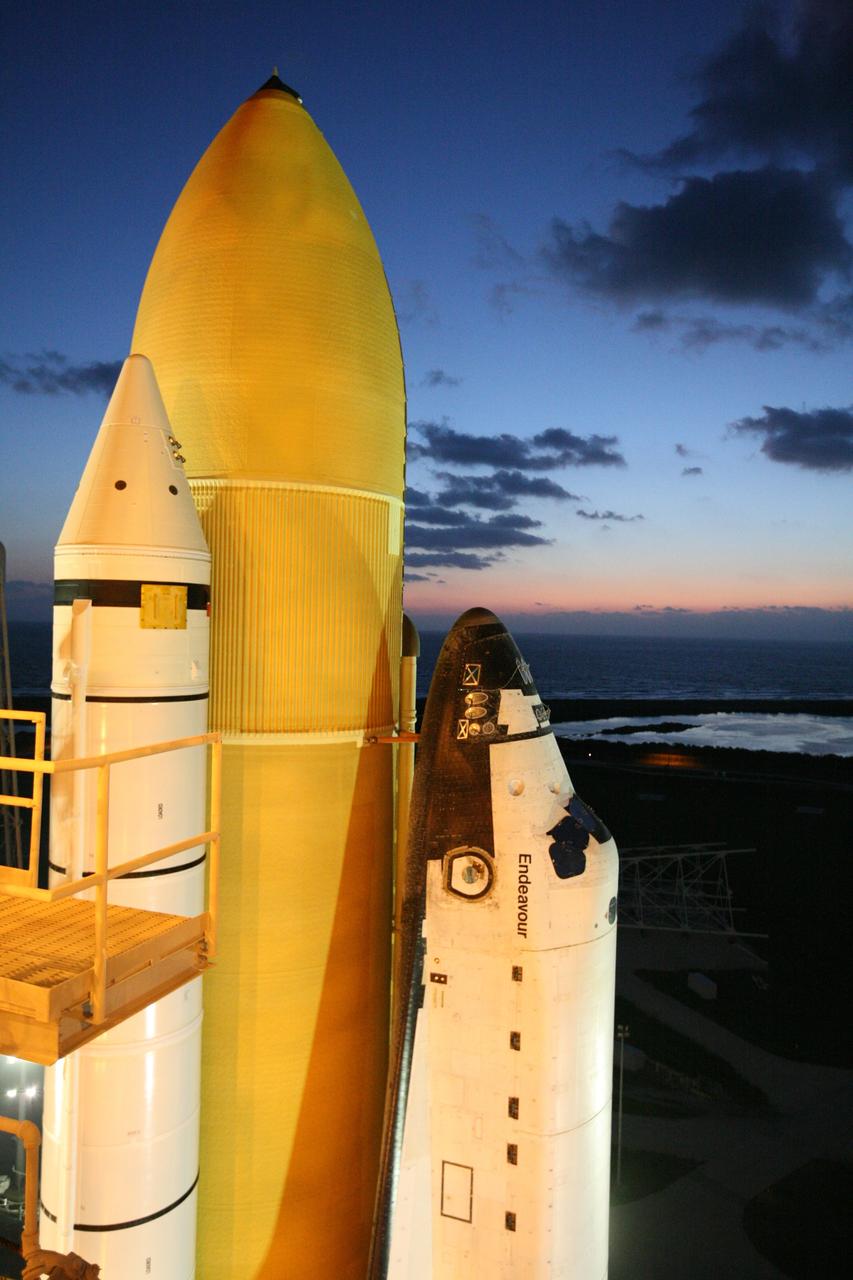 CAPE CANAVERAL, Fla. -  Space shuttle Endeavour is framed against a breaking-dawn sky after arriving on Launch Pad 39B. The shuttle includes the while solid rocket boosters and orange external fuel tank at left. First motion out of the VAB was at 11:15 p.m. Sept. 18. Endeavour completed the 4.2-mile journey to Launch Pad 39B on Sept. 19 at 6:59 a.m. EDT. For the first time since July 2001, two shuttles are on the launch pads at the same time at the center. Endeavour will stand by at pad B in the unlikely event that a rescue mission is necessary during space shuttle Atlantis' upcoming mission to repair NASA's Hubble Space Telescope, targeted to launch Oct. 10. After Endeavour is cleared from its duty as a rescue spacecraft, it will be moved to Launch Pad 39A for the STS-126 mission to the International Space Station. That flight is targeted for launch Nov. 12. Photo credit: NASA/Dimitri Gerondidakis