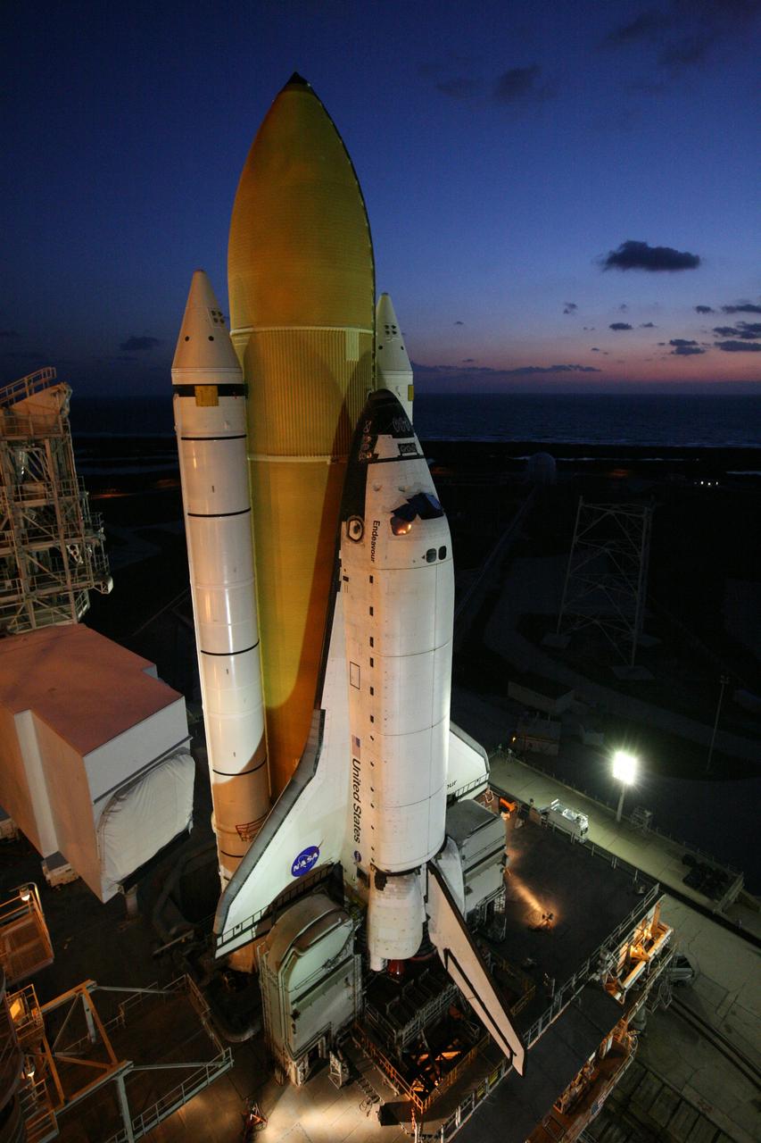 CAPE CANAVERAL, Fla. -  Sitting atop its mobile launcher platform, space shuttle Endeavour welcomes the dawn after arriving on Launch Pad 39B. The shuttle includes the while solid rocket boosters and orange external fuel tank. First motion out of the VAB was at 11:15 p.m. Sept. 18. Endeavour completed the 4.2-mile journey to Launch Pad 39B on Sept. 19 at 6:59 a.m. EDT. For the first time since July 2001, two shuttles are on the launch pads at the same time at the center. Endeavour will stand by at pad B in the unlikely event that a rescue mission is necessary during space shuttle Atlantis' upcoming mission to repair NASA's Hubble Space Telescope, targeted to launch Oct. 10. After Endeavour is cleared from its duty as a rescue spacecraft, it will be moved to Launch Pad 39A for the STS-126 mission to the International Space Station. That flight is targeted for launch Nov. 12. Photo credit: NASA/Dimitri Gerondidakis