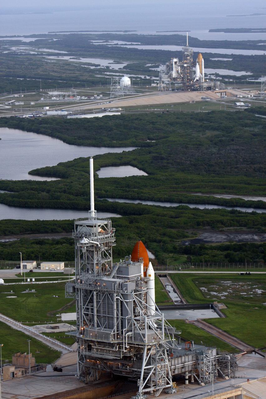 CAPE CANAVERAL, Fla. - An aerial view of the Launch Complex at NASA's Kennedy Space Center shows space shuttles on both pads. At top is space shuttle Endeavour, which rolled out Sept. 19, completing the 4.2-mile journey at 6:59 a.m. EDT. In the foreground is space shuttle Atlantis, preparing for its launch on the STS-125 mission to repair NASA's Hubble Space Telescope, targeted for Oct. 10. This is the first time since July 2001 that two shuttles are on the launch pads at the same time at the center. Endeavour will stand by at pad B in the unlikely event that a rescue mission is necessary during space shuttle Atlantis' upcoming mission. After Endeavour is cleared from its duty as a rescue spacecraft, it will be moved to Launch Pad 39A for the STS-126 mission to the International Space Station. That flight is targeted for launch Nov. 12. Photo credit: NASA/Troy Cryder