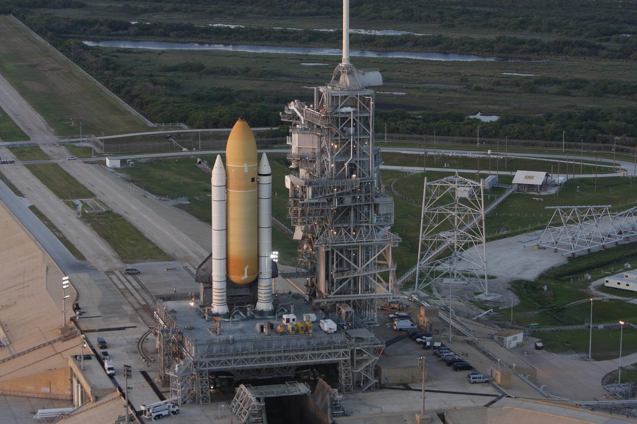 CAPE CANAVERAL, Fla. -  Space shuttle Endeavour is viewed from the air on Launch Pad 39B after the rollout from the Vehicle Assembly Building at NASA's Kennedy Space Center.  To the right of the shuttle is the fixed service structure with the 80-foot lightning mast on top. First motion out of the Vehicle Assembly Building was at 11:15 p.m. Sept. 18.  Endeavour completed the 4.2-mile journey at 6:59 a.m. EDT. For the first time since July 2001, two shuttles are on the launch pads at the same time at the center. Endeavour will stand by at pad B in the unlikely event that a rescue mission is necessary during space shuttle Atlantis' upcoming mission to repair NASA's Hubble Space Telescope, targeted to launch Oct. 10. After Endeavour is cleared from its duty as a rescue spacecraft, it will be moved to Launch Pad 39A for the STS-126 mission to the International Space Station. That flight is targeted for launch Nov. 12. Photo credit: NASA/Troy Cryder