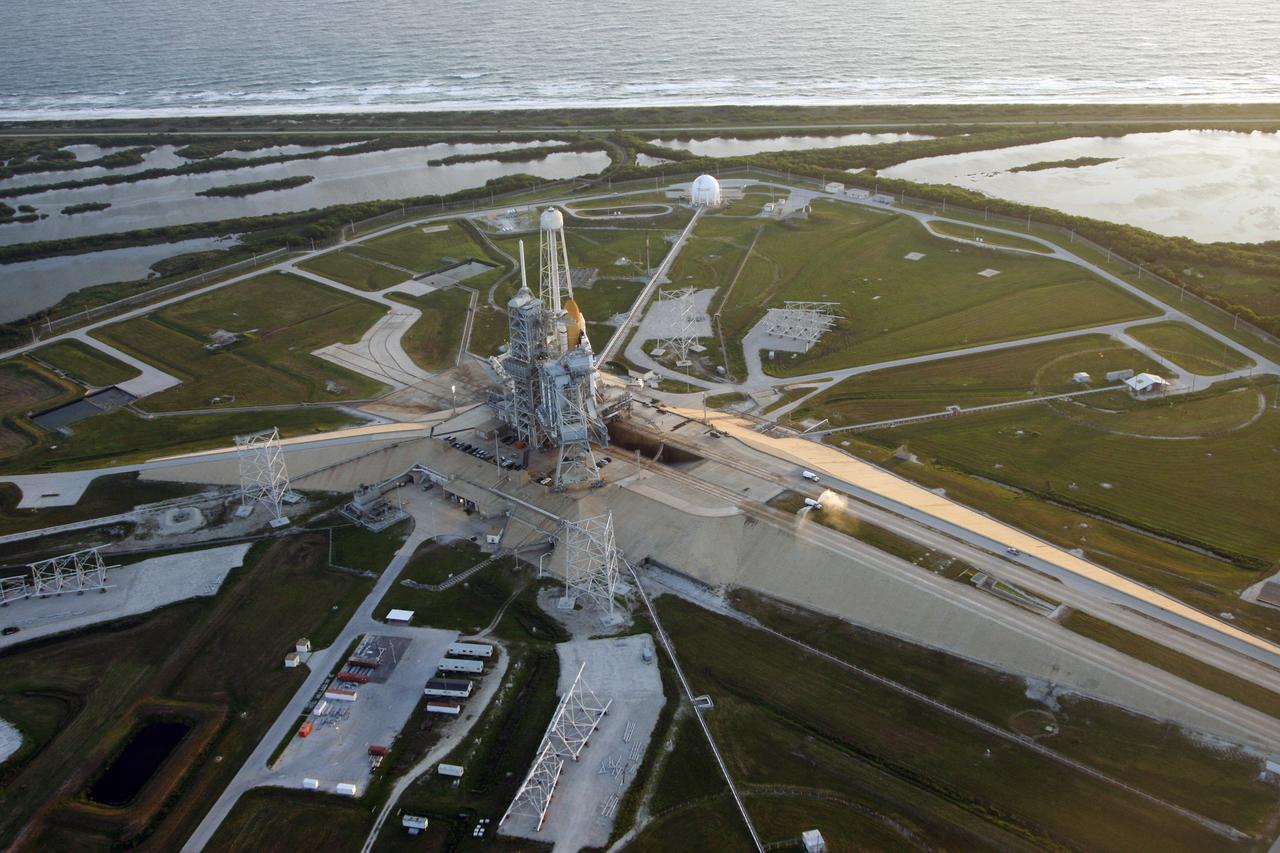 CAPE CANAVERAL, Fla. -   The aerial view of Launch Pad 39B at NASA's Kennedy Space Center shows the Atlantic Ocean at top, the Banana River closer to the pad, and space shuttle Endeavour after its rollout from the Vehicle Assembly Building.  At left of the shuttle is the open rotating service structure and the fixed service structure with the 80-foot lightning mast on top. Behind them are the tower that holds 300,000 gallons of water used for sound suppression on the pad during liftoff. First motion of Endeavour out of the VAB was at 11:15 p.m. Sept. 18. Endeavour completed the 4.2-mile journey at 6:59 a.m. EDT. For the first time since July 2001, two shuttles are on the launch pads at the same time at the center. Endeavour will stand by at pad B in the unlikely event that a rescue mission is necessary during space shuttle Atlantis' upcoming mission to repair NASA's Hubble Space Telescope, targeted to launch Oct. 10. After Endeavour is cleared from its duty as a rescue spacecraft, it will be moved to Launch Pad 39A for the STS-126 mission to the International Space Station. That flight is targeted for launch Nov. 12. Photo credit: NASA/Troy Cryder