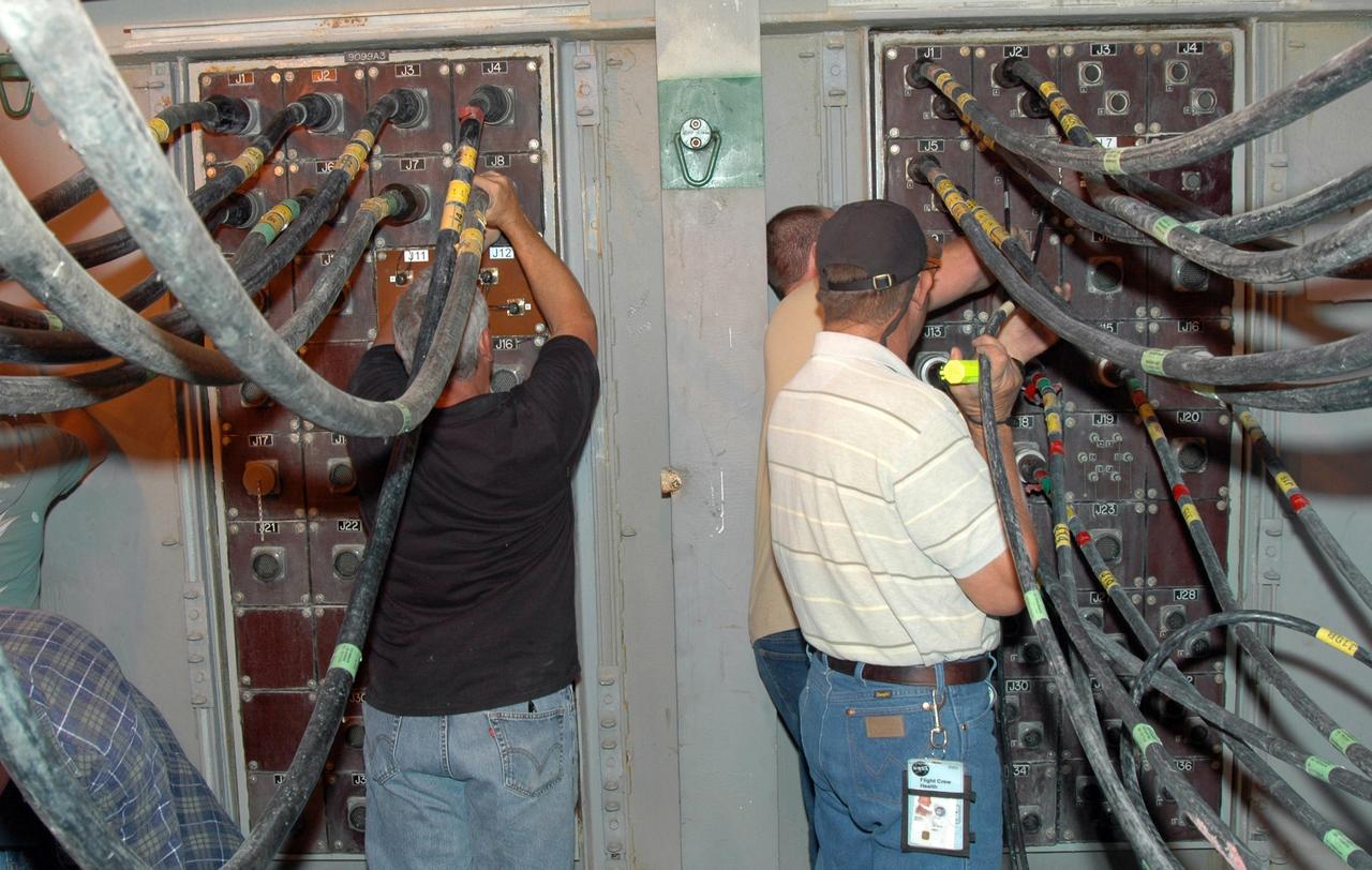 CAPE CANAVERAL, Fla. - After rollout from the Vehicle Assembly Building at NASA's Kennedy Space Center, space shuttle Endeavour is secure on the launch pad. Workers on the pad connect lines on the mobile launcher platform. Endeavour completed the 4.2-mile rollout at 6:59 a.m. EDT. For the first time since July 2001, two shuttles are on the launch pads at the same time at the center. Endeavour will stand by at pad B in the unlikely event that a rescue mission is necessary during space shuttle Atlantis' upcoming mission to repair NASA's Hubble Space Telescope, targeted to launch Oct. 10. After Endeavour is cleared from its duty as a rescue spacecraft, it will be moved to Launch Pad 39A for the STS-126 mission to the International Space Station. That flight is targeted for launch Nov. 12. Photo credit: NASA/Jim Grossmann