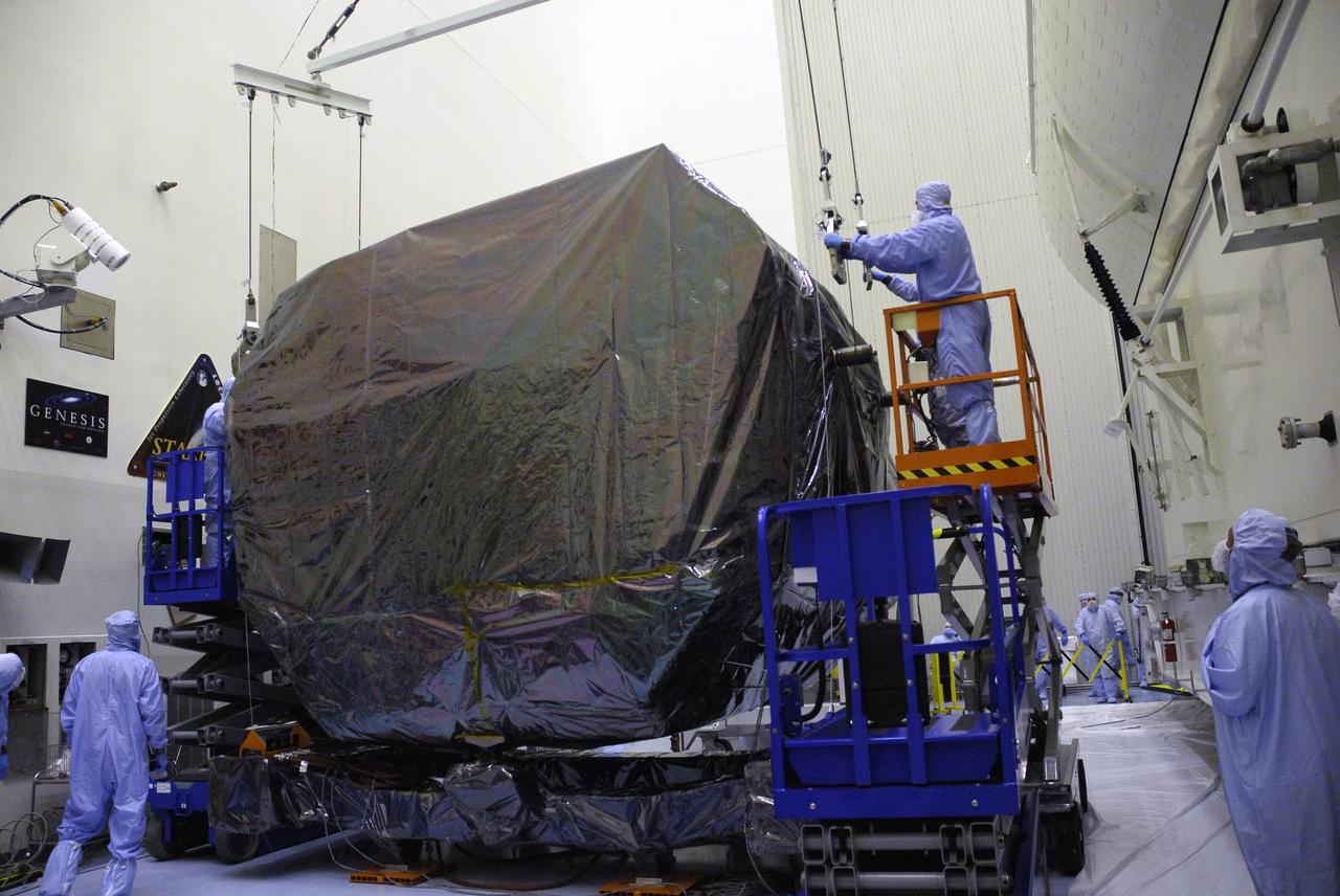 CAPE CANAVERAL, Fla. -  In the Payload Hazardous Servicing Facility at NASA's Kennedy Space Center, workers attach an overhead crane to the Orbital Replacement Unit Carrier, or ORUC.  The crane will lift and move the ORUC to the payload canister. The carrier is one of four associated with the STS-125 mission to service the Hubble Space Telescope. It will be installed in the payload canister for transfer to Launch Pad 39A. At the pad, all the carriers will be loaded into space shuttle Atlantis’ payload bay. Launch of Atlantis is targeted for Oct. 10.  Photo credit: NASA/Jack Pfaller