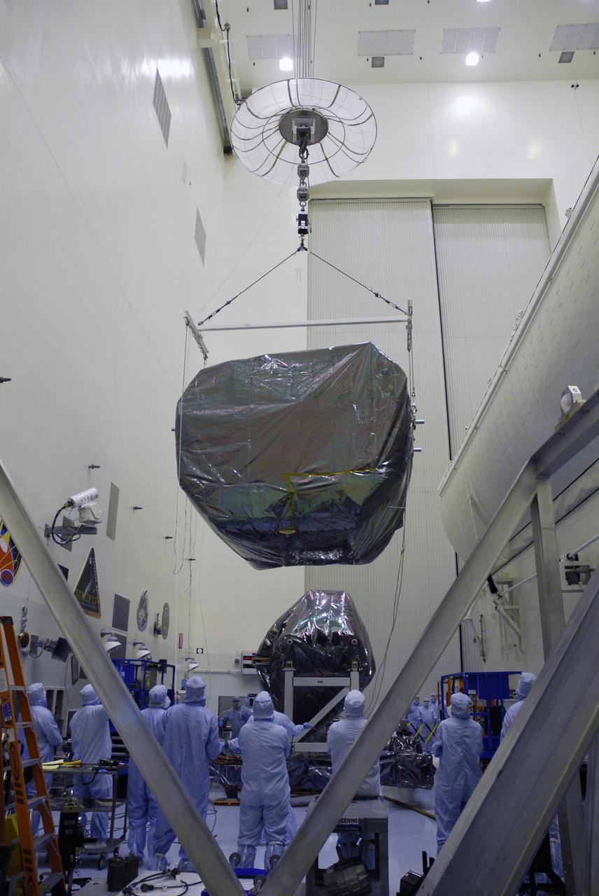 CAPE CANAVERAL, Fla. -  In the Payload Hazardous Servicing Facility at NASA's Kennedy Space Center, an overhead crane lifts the Orbital Replacement Unit Carrier, or ORUC, to install it in the payload canister at right. The carrier is one of four associated with the STS-125 mission to service the Hubble Space Telescope. It will be installed in the payload canister for transfer to Launch Pad 39A. At the pad, all the carriers will be loaded into space shuttle Atlantis’ payload bay. Launch of Atlantis is targeted for Oct. 10.  Photo credit: NASA/Jack Pfaller