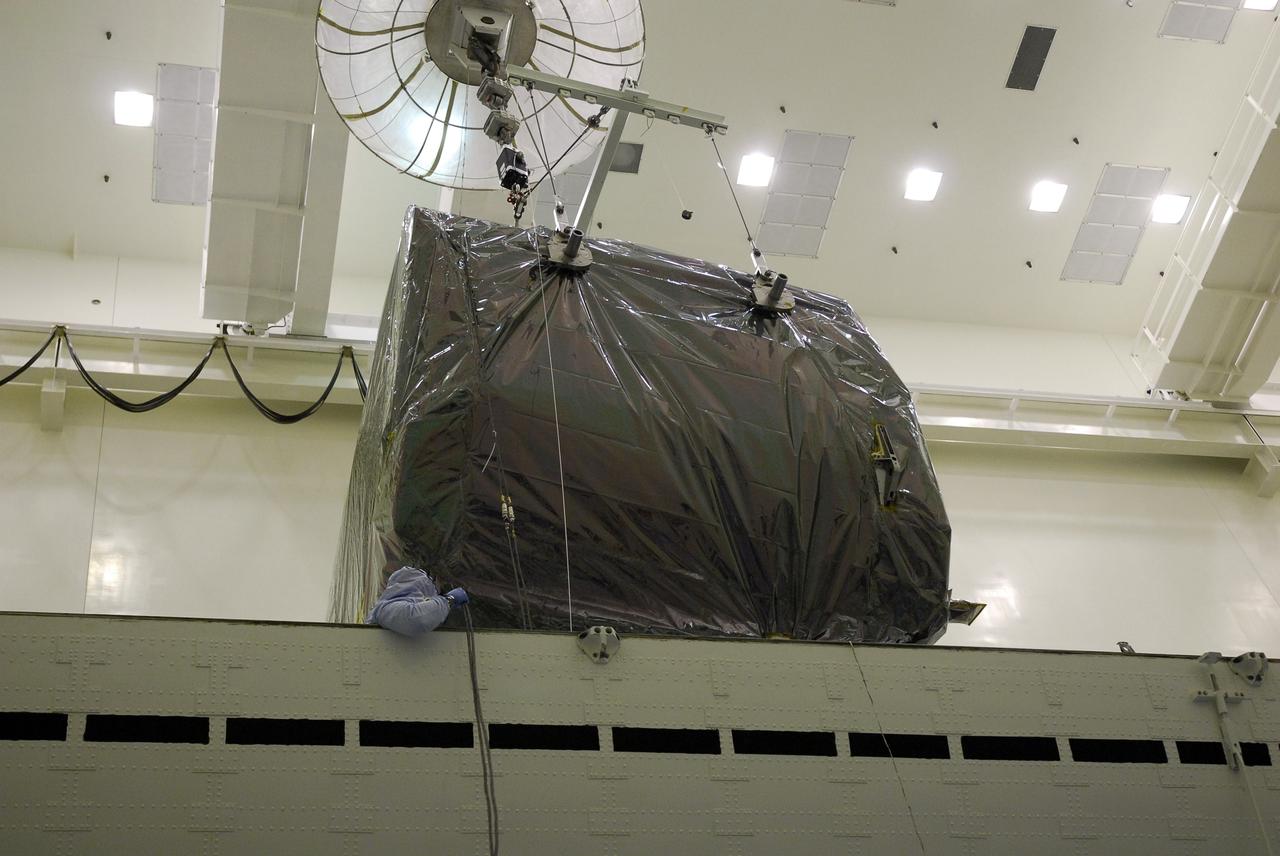 CAPE CANAVERAL, Fla. -  In the Payload Hazardous Servicing Facility at NASA's Kennedy Space Center, an overhead crane moves the Orbital Replacement Unit Carrier, or ORUC, above the payload canister for installation.  The carrier is one of four associated with the STS-125 mission to service the Hubble Space Telescope. It will be installed in the payload canister for transfer to Launch Pad 39A. At the pad, all the carriers will be loaded into space shuttle Atlantis’ payload bay. Launch of Atlantis is targeted for Oct. 10.  Photo credit: NASA/Jack Pfaller