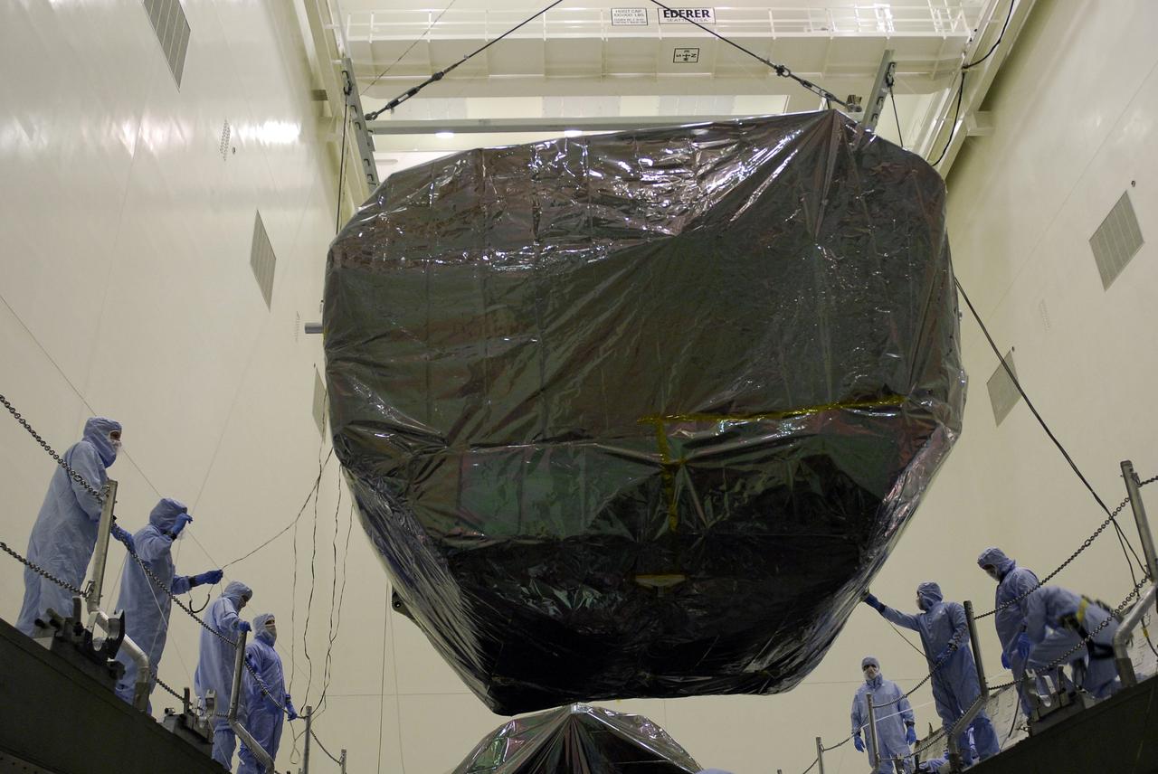 CAPE CANAVERAL, Fla. -  In the Payload Hazardous Servicing Facility at NASA's Kennedy Space Center, an overhead crane lowers the Orbital Replacement Unit Carrier, or ORUC, into the payload canister.  It will be placed next to the Flight Support System carrier already in the canister.  The carrier is one of four associated with the STS-125 mission to service the Hubble Space Telescope. It will be installed in the payload canister for transfer to Launch Pad 39A. At the pad, all the carriers will be loaded into space shuttle Atlantis’ payload bay. Launch of Atlantis is targeted for Oct. 10.  Photo credit: NASA/Jack Pfaller