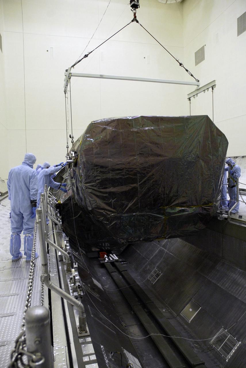 CAPE CANAVERAL, Fla. -  In the Payload Hazardous Servicing Facility at NASA's Kennedy Space Center, an overhead crane lowers the Orbital Replacement Unit Carrier, or ORUC, into the payload canister.  It is being placed next to the Flight Support System carrier already in the canister. The carrier is one of four associated with the STS-125 mission to service the Hubble Space Telescope. It will be installed in the payload canister for transfer to Launch Pad 39A. At the pad, all the carriers will be loaded into space shuttle Atlantis’ payload bay. Launch of Atlantis is targeted for Oct. 10.  Photo credit: NASA/Jack Pfaller