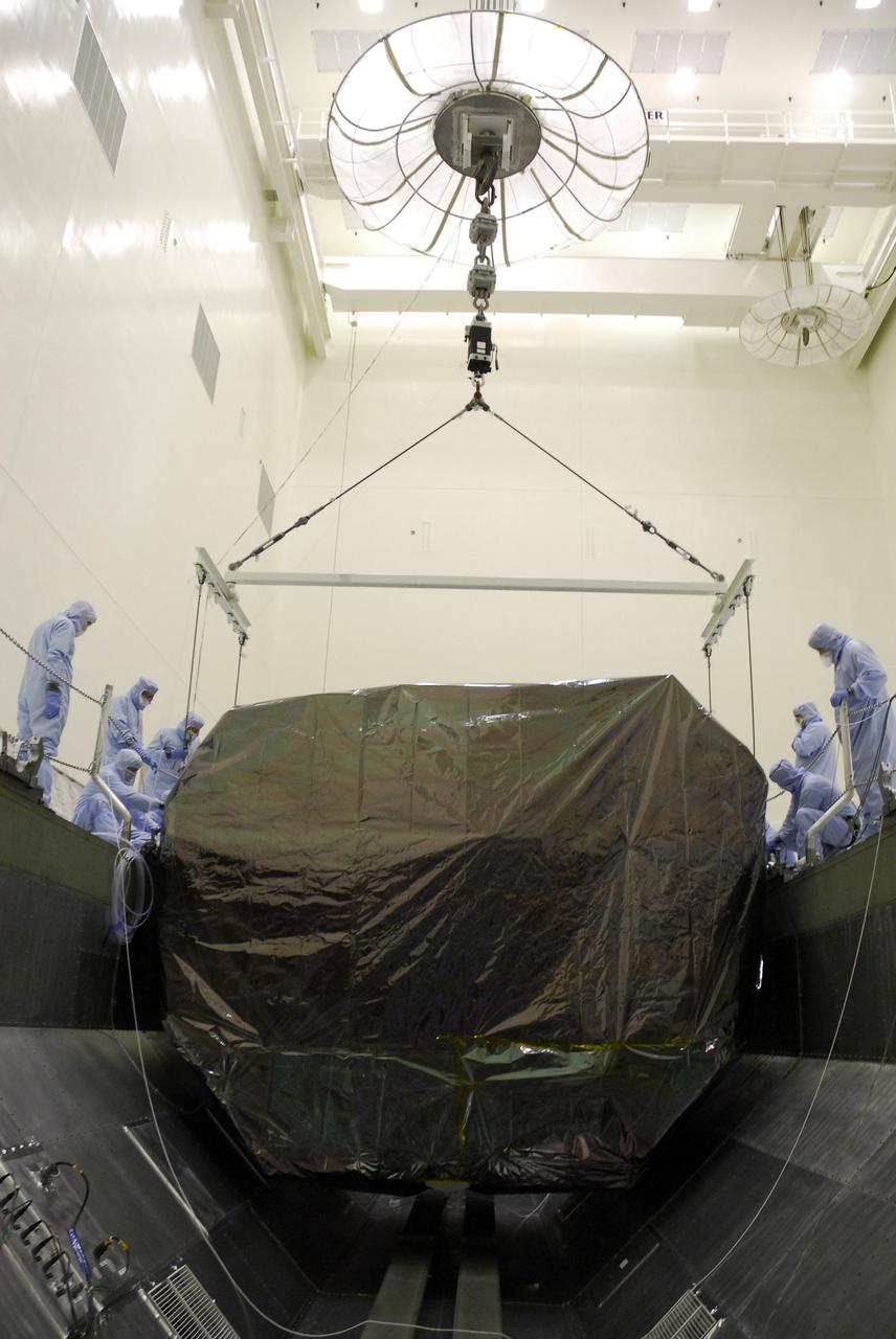 CAPE CANAVERAL, Fla. -  In the Payload Hazardous Servicing Facility at NASA's Kennedy Space Center, an overhead crane lowers the Orbital Replacement Unit Carrier, or ORUC, into the payload canister.  It is being placed next to the Flight Support System carrier already in the canister.  The carrier is one of four associated with the STS-125 mission to service the Hubble Space Telescope. It will be installed in the payload canister for transfer to Launch Pad 39A. At the pad, all the carriers will be loaded into space shuttle Atlantis’ payload bay. Launch of Atlantis is targeted for Oct. 10.  Photo credit: NASA/Jack Pfaller