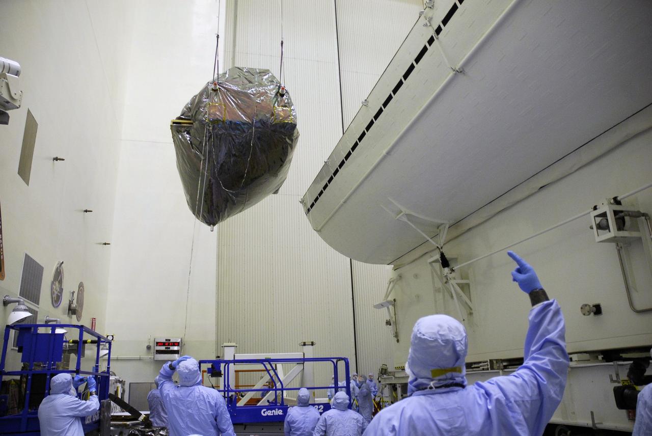 CAPE CANAVERAL, Fla. -  In the Payload Hazardous Servicing Facility at NASA's Kennedy Space Center, an overhead crane suspends the Super Lightweight Interchangeable Carrier, or SLIC, as it transfers the carrier to the payload canister at right.  The SLIC, one of four carriers associated with the STS-125 mission to service the Hubble Space Telescope, will be moved to Launch Pad 39A. At the pad, all the carriers will be loaded into space shuttle Atlantis’ payload bay. Launch of Atlantis is targeted for Oct. 10.  Photo credit: NASA/Jack Pfaller