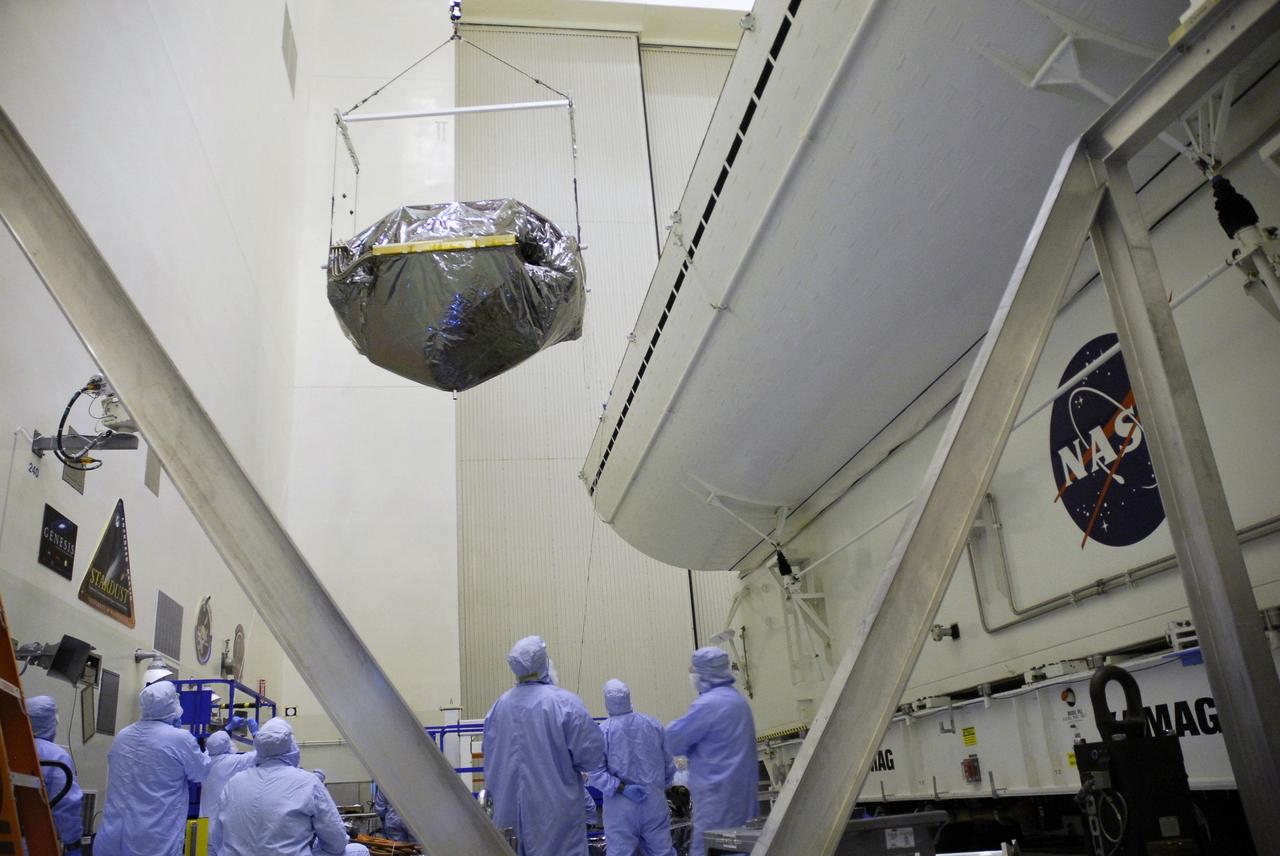 CAPE CANAVERAL, Fla. -  In the Payload Hazardous Servicing Facility at NASA's Kennedy Space Center, an overhead crane suspends the Super Lightweight Interchangeable Carrier, or SLIC, as it transfers the carrier to the payload canister at right.  The SLIC, one of four carriers associated with the STS-125 mission to service the Hubble Space Telescope, will be moved to Launch Pad 39A.  At the pad, all the carriers will be loaded into space shuttle Atlantis’ payload bay. Launch of Atlantis is targeted for Oct. 10.  Photo credit: NASA/Jack Pfaller