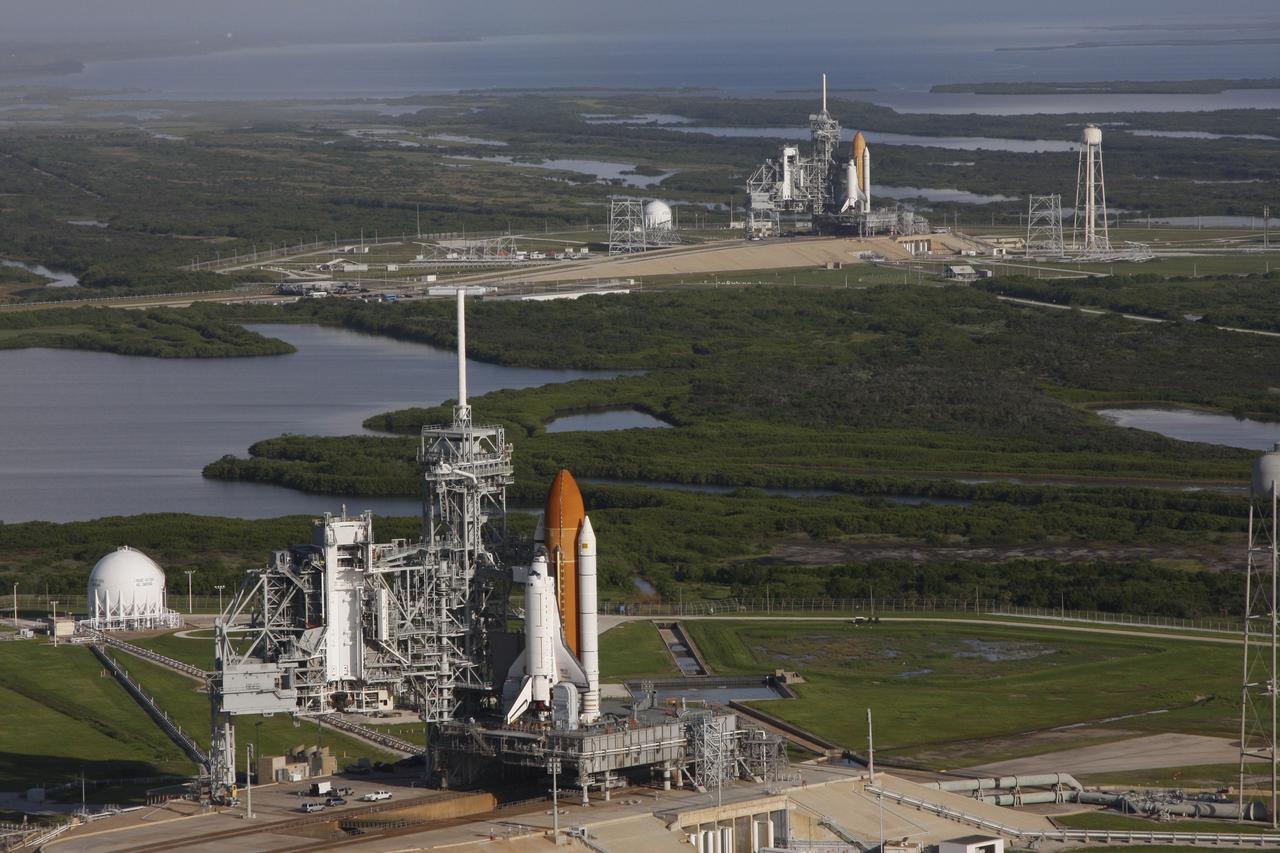 CAPE CANAVERAL, Fla. - Space shuttle Atlantis (foreground) sits on Launch Pad A and Endeavour on Launch Pad B at NASA’s Kennedy Space Center in Florida. At the left of each shuttle are the open rotating service structures with the payload changeout rooms revealed. The rotating service structures provide protection for weather and access to the shuttle. For the first time since July 2001, two shuttles are on the launch pads at the same time at the center. Endeavour will stand by at pad B in the unlikely event that a rescue mission is necessary during space shuttle Atlantis’ upcoming mission to repair NASA’s Hubble Space Telescope, targeted to launch Oct. 10. After Endeavour is cleared from its duty as a rescue spacecraft, it will be moved to Launch Pad 39A for its STS-126 mission to the International Space Station. That flight is targeted for launch Nov. 12. Photo credit: NASA/Troy Cryder