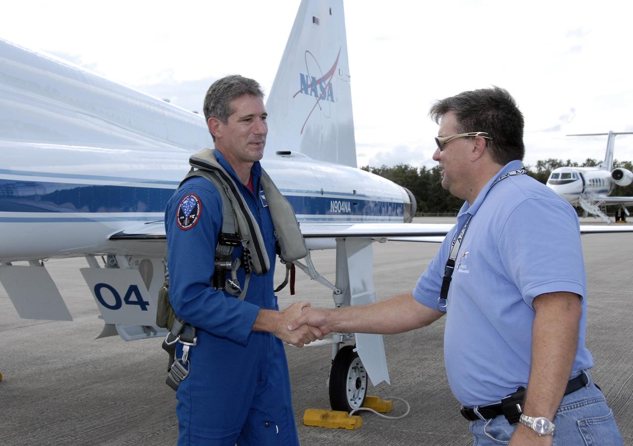 CAPE CANAVERAL, Fla. -  STS-125 mission specialist Michael Good greets a worker at the Shuttle Landing Facility at NASA’s Kennedy Space Center in Florida after arriving in a T-38 jet for Terminal Countdown Demonstration Test, or TCDT, activities. During TCDT, space shuttle Atlantis’ STS-125 crew members will participate in a simulated launch countdown, practice emergency egress procedures at the launch pad and continue to familiarize themselves with the mission payload and hardware. STS-125 is the fifth and final shuttle Hubble Space Telescope servicing mission. Launch is targeted for Oct. 10. Photo credit: NASA/Kim Shiflett