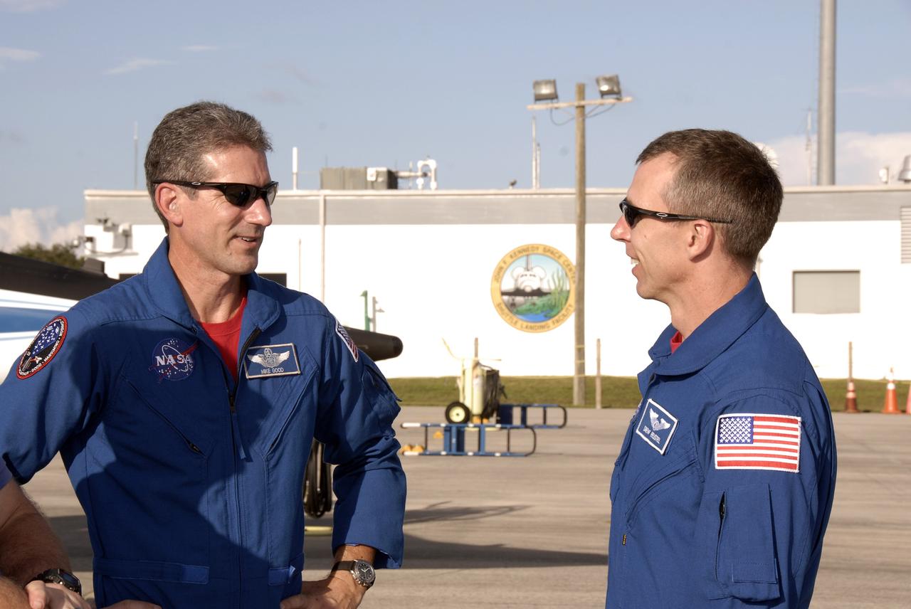 CAPE CANAVERAL, Fla. -  STS-125 mission specialists Michael Good (left) and Andrew Feustel greet each other after arriving at the Shuttle Landing Facility at NASA’s Kennedy Space Center in Florida in T-38 jets. They and the other five crew members are at the center for Terminal Countdown Demonstration Test, or TCDT, activities. During TCDT, space shuttle Atlantis’ STS-125 crew members will participate in a simulated launch countdown, practice emergency egress procedures at the launch pad and continue to familiarize themselves with the mission payload and hardware. STS-125 is the fifth and final shuttle Hubble Space Telescope servicing mission. Launch is targeted for Oct. 10. Photo credit: NASA/Kim Shiflett