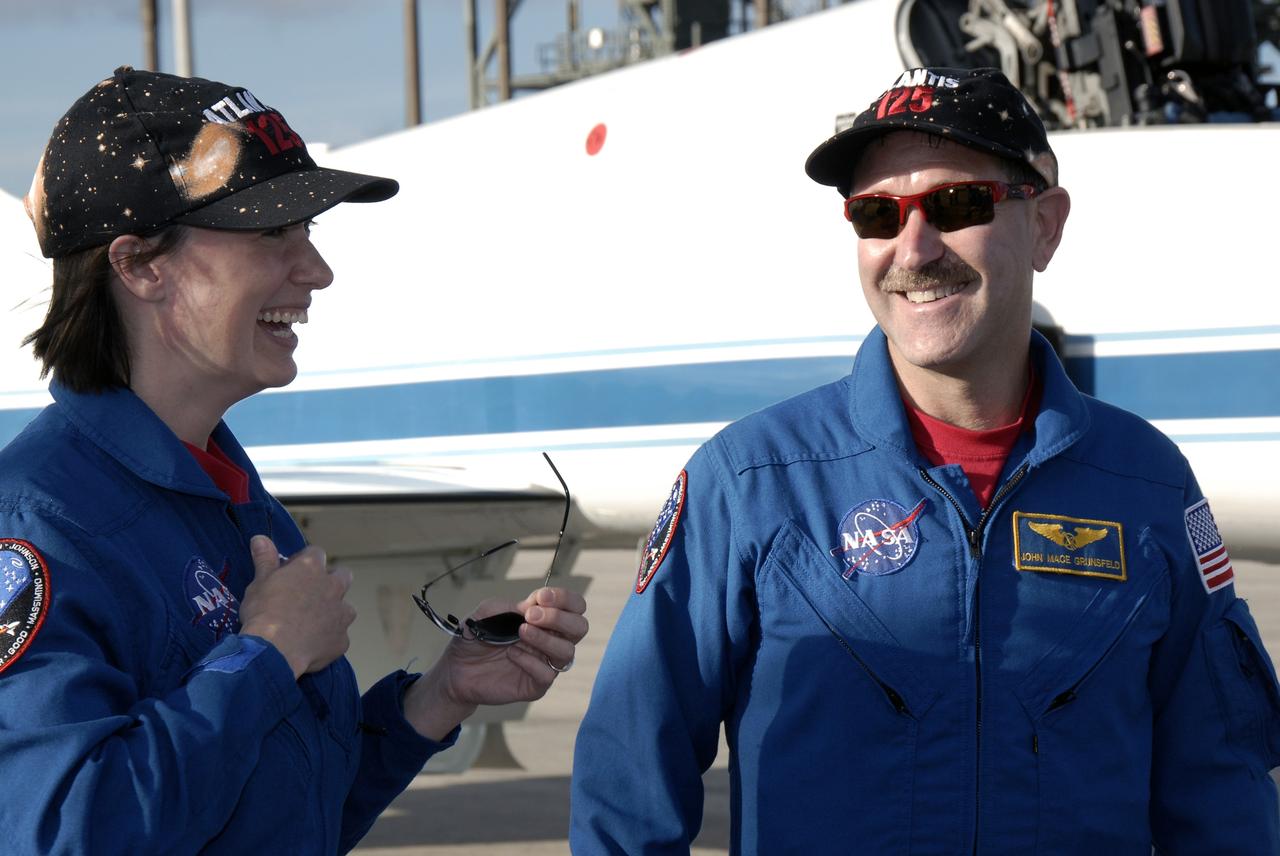 CAPE CANAVERAL, Fla. -  STS-125 mission specialist John Grunsfeld arrives at the Shuttle Landing Facility at NASA’s Kennedy Space Center in Florida for Terminal Countdown Demonstration Test, or TCDT, activities. To his left is mission specialist Megan McArthur. During TCDT, space shuttle Atlantis’ STS-125 crew members will participate in a simulated launch countdown, practice emergency egress procedures at the launch pad and continue to familiarize themselves with the mission payload and hardware. STS-125 is the fifth and final shuttle Hubble Space Telescope servicing mission. Launch is targeted for Oct. 10. Photo credit: NASA/Kim Shiflett