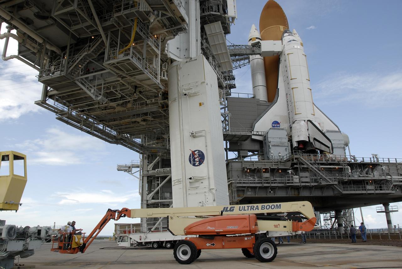 CAPE CANAVERAL, Fla. -  At Launch Pad 39A at NASA’s Kennedy Space Center in Florida, technicians work to move the Hubble payload canister into the payload changeout room for space shuttle Atlantis’ STS-125 mission.  The canister arrived at the pad on Saturday evening, however, early Sunday morning technicians were unable to place the canister into the pad’s payload changeout room. Teflon pads on “shoes” attached to the outside of the payload canister that help the canister move along guide rails didn’t fit properly. The shoes, one seen here, were removed and several options were considered, including slightly shaving down the pads so the shoes will fit onto the rails.  STS-125 is the fifth and final shuttle Hubble Space Telescope servicing mission. Atlantis’ launch is targeted for Oct. 10. Photo credit: NASA/Kim Shiflett.