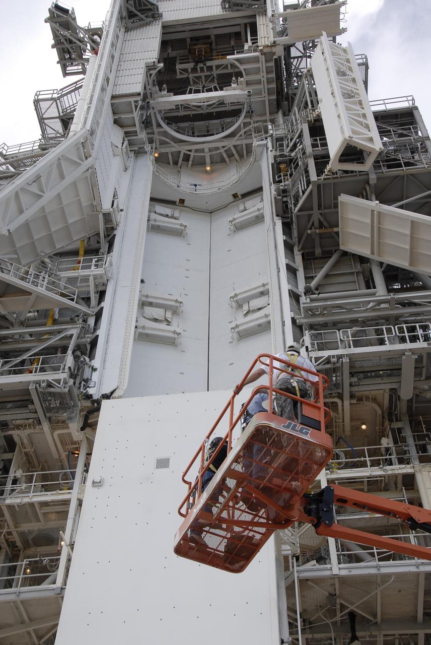 CAPE CANAVERAL, Fla. -  At Launch Pad 39A at NASA’s Kennedy Space Center in Florida, technicians work to move the Hubble payload canister into the payload changeout room for space shuttle Atlantis’ STS-125 mission.  The canister arrived at the pad on Saturday evening; however, early Sunday morning technicians were unable to place the canister into the pad’s payload changeout room. Teflon pads on “shoes” attached to the outside of the payload canister that help the canister move along the guide rails didn’t fit properly. The shoes were removed and several options were considered, including slightly shaving down the pads so the shoes will fit onto the rails. STS-125 is the fifth and final shuttle Hubble Space Telescope servicing mission. Atlantis’ launch is targeted for Oct. 10. Photo credit: NASA/Kim Shiflett.