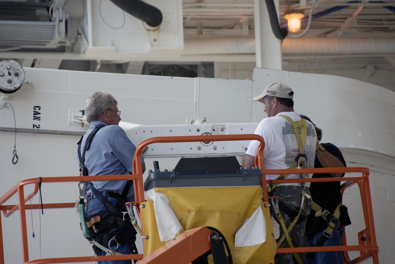 CAPE CANAVERAL, Fla. -  At Launch Pad 39A at NASA’s Kennedy Space Center in Florida, technicians work to move the Hubble payload canister into the payload changeout room for space shuttle Atlantis’ STS-125 mission.  The canister arrived at the pad on Saturday evening; however, early Sunday morning technicians were unable to place the canister into the pad’s payload changeout room. Teflon pads on “shoes” attached to the outside of the payload canister that help the canister move along the guide rails didn’t fit properly. The shoes were removed and several options were considered, including slightly shaving down the pads so the shoes will fit onto the rails. STS-125 is the fifth and final shuttle Hubble Space Telescope servicing mission. Atlantis’ launch is targeted for Oct. 10. Photo credit: NASA/Kim Shiflett.