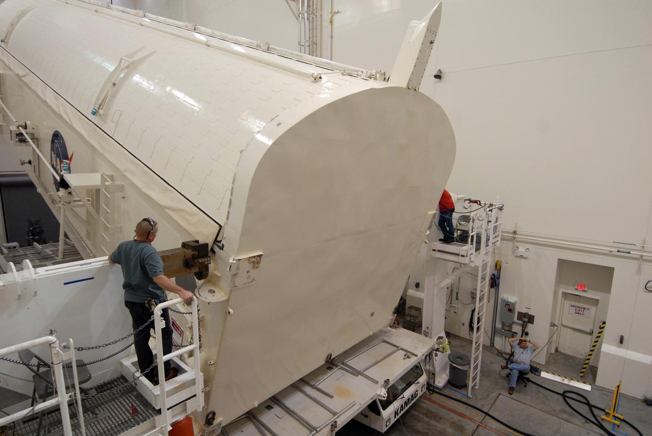 CAPE CANAVERAL, Fla. -   In the Canister Rotation Facility at NASA's Kennedy Space Center, the payload canister is lifted toward a vertical position for the trip to Launch Pad 39A. The canister’s cargo consists of four carriers holding various equipment for the STS-125 mission aboard space shuttle Atlantis to service NASA’s Hubble Space Telescope.  At the pad, the cargo will be moved into the Payload Changeout Room.  The changeout room is the enclosed, environmentally controlled portion of the rotating service structure that supports cargo delivery to the pad and subsequent vertical installation into the shuttle’s payload bay. Launch of Atlantis is targeted for Oct. 10.   Photo credit: NASA/Jack Pfaller