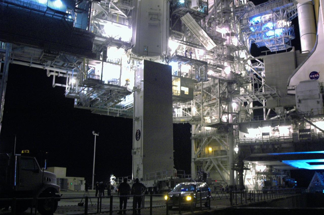 CAPE CANAVERAL, Fla. - On Launch Pad 39A at NASA's Kennedy Space Center, the payload canister is ready for another attempt to be lifted to the payload changeout room. The first attempt encountered problems when Teflon pads on “shoes” attached to the outside of the canister that go onto guide rails to help the canister into the room didn’t fit properly. The two shoes were removed, slightly shaved down so that they would fit into the rails and put back on the canister. The changeout room is the enclosed, environmentally controlled portion of the rotating service structure that supports cargo delivery to the pad and subsequent vertical installation into the shuttle’s payload bay. Launch of Atlantis is targeted for Oct. 10. Photo credit: NASA/Jim Grossmann