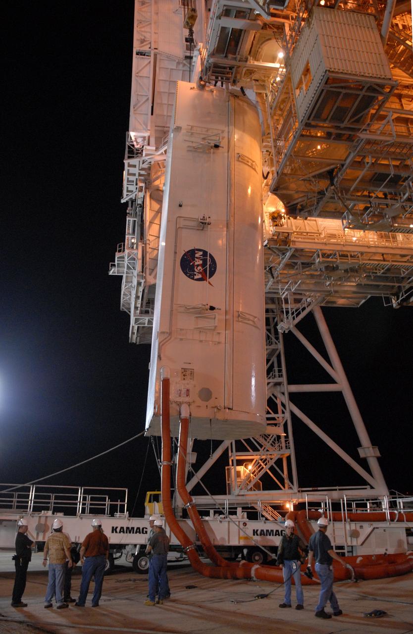 CAPE CANAVERAL, Fla. -  On Launch Pad 39A at NASA's Kennedy Space Center, the payload canister is lifted toward the payload changeout room above.  The canister contains four carriers holding various equipment for the STS-125 mission aboard space shuttle Atlantis to service NASA’s Hubble Space Telescope. The changeout room is the enclosed, environmentally controlled portion of the rotating service structure that supports cargo delivery to the pad and subsequent vertical installation into the shuttle’s payload bay. Launch of Atlantis is targeted for Oct. 10.   Photo credit: NASA/Jack Pfaller