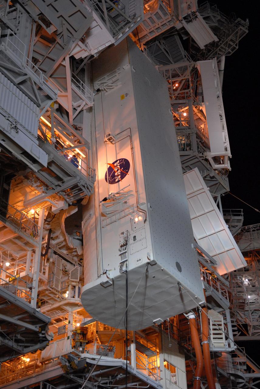 CAPE CANAVERAL, Fla. -  On Launch Pad 39A at NASA's Kennedy Space Center, the payload canister is lifted to the payload changeout room above.  The canister contains four carriers holding various equipment for the STS-125 mission aboard space shuttle Atlantis to service NASA’s Hubble Space Telescope.  The changeout room is the enclosed, environmentally controlled portion of the rotating service structure that supports cargo delivery to the pad and subsequent vertical installation into the shuttle’s payload bay. Launch of Atlantis is targeted for Oct. 10.   Photo credit: NASA/Jack Pfaller