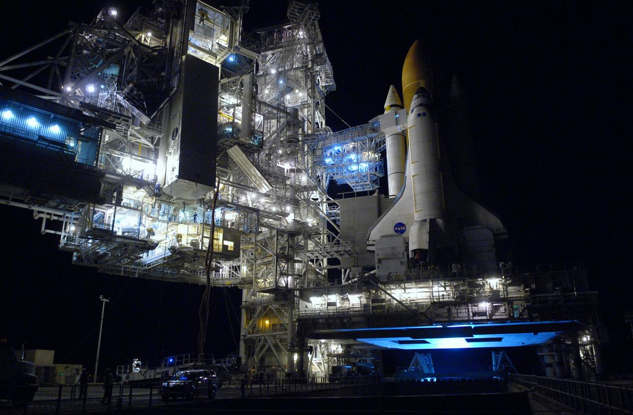 CAPE CANAVERAL, Fla. - On Launch Pad 39A at NASA's Kennedy Space Center, the payload canister is in place at the payload changeout room on the rotating service structure. The canister contains four carriers holding various equipment for the STS-125 mission aboard space shuttle Atlantis to service NASA’s Hubble Space Telescope. At right is Atlantis, atop the mobile launcher platform. The changeout room is the enclosed, environmentally controlled portion of the rotating service structure that supports cargo delivery to the pad and subsequent vertical installation into the shuttle’s payload bay. Launch of Atlantis is targeted for Oct. 10. Photo credit: NASA/Jack Pfaller