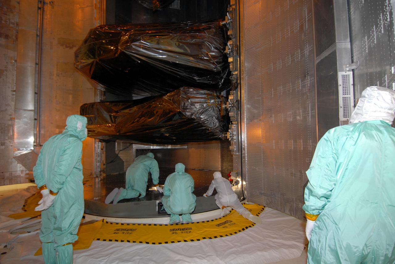 CAPE CANAVERAL, Fla. -    Inside the payload changeout room, or PCR, at NASA's Kennedy Space Center Launch Pad 39A, workers prepare for the transfer of the payload from the canister into the PCR.  The payload comprises four carriers holding various equipment for the STS-125 mission aboard space shuttle Atlantis to service NASA’s Hubble Space Telescope. The PCR is the enclosed, environmentally controlled portion of the rotating service structure that supports cargo delivery to the pad and subsequent vertical installation into the shuttle’s payload bay. Launch of Atlantis is targeted for Oct. 10. Photo credit: NASA/Jack Pfaller
