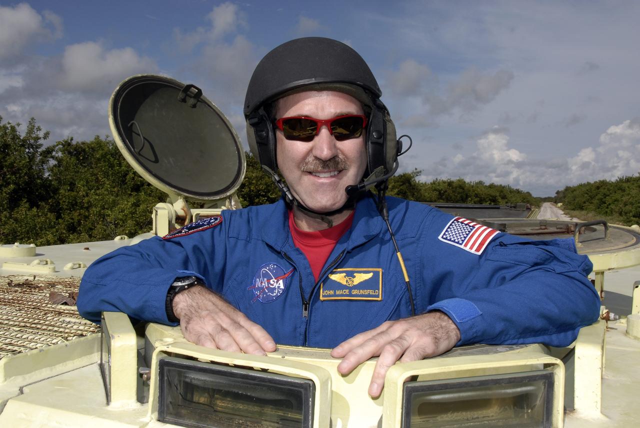 CAPE CANAVERAL, Fla. -  STS-125 Mission Specialist John Grunsfeld is ready to practice driving the M-113 armored personnel carrier. The crew members of space shuttle Atlantis' STS-125 mission will each practice driving the M-113 in turn as part of their training on emergency egress procedures. An M-113 will be available to transport the crew to safety in the event of a contingency on the pad before their launch. The crew is at NASA's Kennedy Space Center for a dress launch rehearsal called the terminal countdown demonstration test, or TCDT. It provides astronauts and ground crews with an opportunity to participate in various simulated countdown activities, including equipment familiarization,  emergency training and a simulated launch countdown. The STS-125 mission aboard space shuttle Atlantis to service NASA’s Hubble Space Telescope is targeted to launch Oct. 10.    Photo credit: NASA/Kim Shiflett