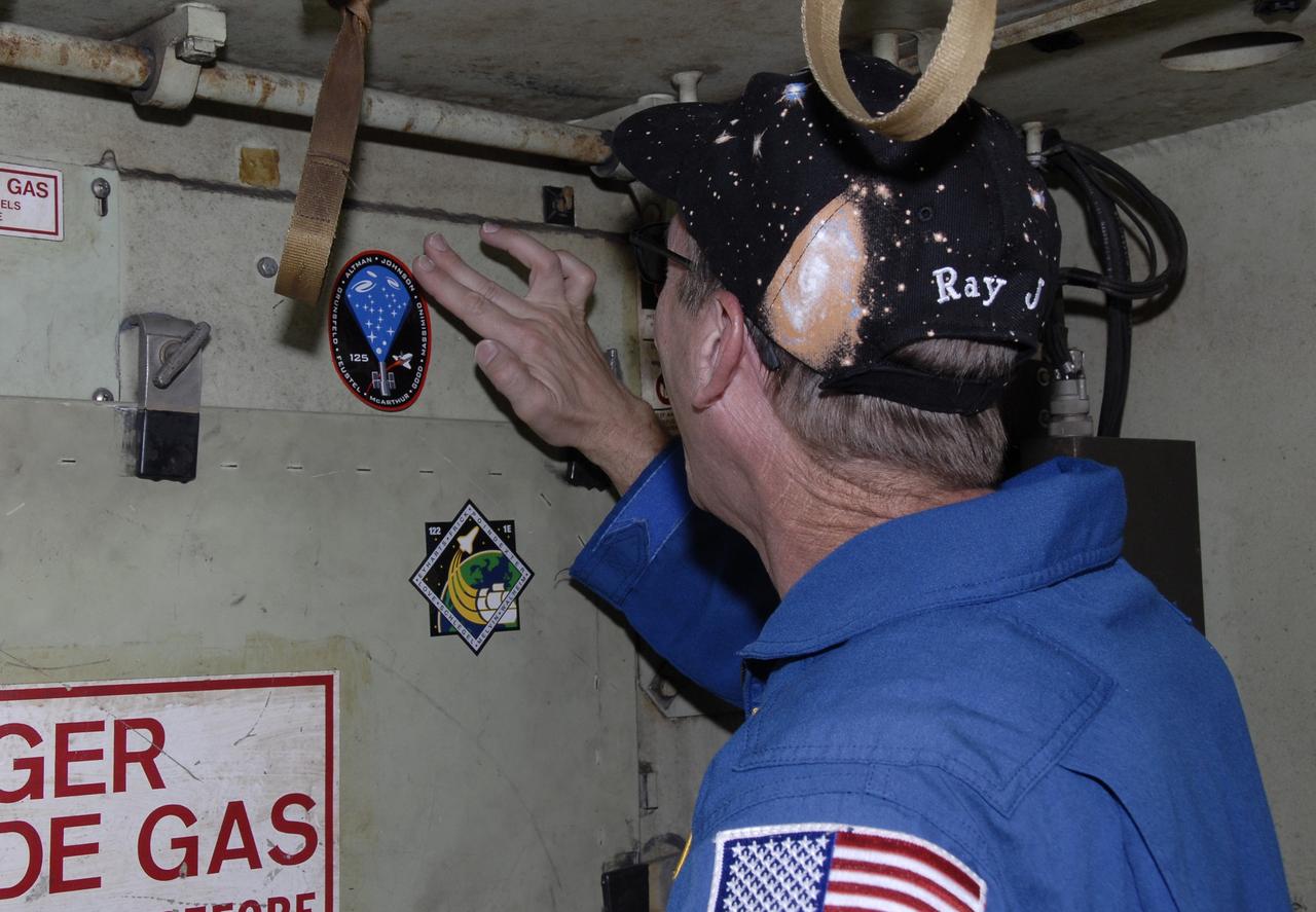 CAPE CANAVERAL, Fla. -  An STS-125 crew member affixes a mission patch to the inside of the M-113 armored personnel carrier the crew practiced driving.The crew members of space shuttle Atlantis' STS-125 mission each practiced driving the M-113 in turn as part of their training on emergency egress procedures. An M-113 will be available to transport the crew to safety in the event of a contingency on the pad before their launch. The crew is at NASA's Kennedy Space Center for a dress launch rehearsal called the terminal countdown demonstration test, or TCDT. It provides astronauts and ground crews with an opportunity to participate in various simulated countdown activities, including equipment familiarization,  emergency training and a simulated launch countdown. The STS-125 mission aboard space shuttle Atlantis to service NASA’s Hubble Space Telescope is targeted to launch Oct. 10.    Photo credit: NASA/Kim Shiflett