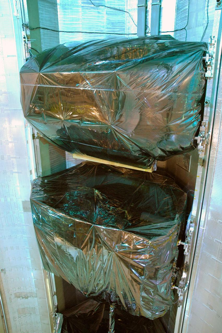CAPE CANAVERAL, Fla. -  In the payload changeout room, or PCR, on Launch Pad 39A at NASA's Kennedy Space Center in Florida, a closeup shows two of the four carriers inside the payload canister that will be transferred into the PCR.  These carriers are the Multi-Use Logistic Equipment carrier (top) and the Flight Support System carrier.  They hold various equipment for the STS-125 mission aboard space shuttle Atlantis to service NASA’s Hubble Space Telescope.  The PGHM removes payloads from a transportation canister and installs them into the shuttle. It is essentially NASA’s largest fork-lift.  Atlantis is targeted to launch Oct. 10.  Photo credit: NASA/Jim Grossmann