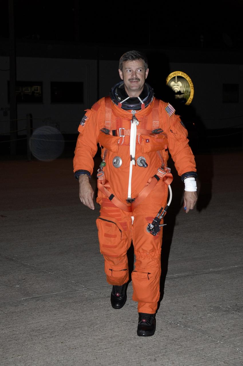 CAPE CANAVERAL, Fla. -  STS-125 Commander Scott Altman walks toward the shuttle training aircraft on the Shuttle Landing Facility at NASA's Kennedy Space Center in Florida.  He will practice shuttle landings on the runway. The STA is a Grumman American Aviation-built Gulf Stream II jet that was modified to simulate a shuttle’s cockpit, motion and visual cues, and handling qualities. In flight, the aircraft duplicates the shuttle’s atmospheric descent trajectory from approximately 35,000 feet altitude to landing on a runway. The practice is part of a terminal countdown demonstration test, or TCDT, to prepare for launch.  TCDT provides astronauts and ground crews with an opportunity to participate in various simulated countdown activities, including equipment familiarization, emergency training and a simulated launch countdown. Space shuttle Atlantis’ STS-125 mission to service NASA’s Hubble Space Telescope is targeted to launch Oct. 10.  Photo credit: NASA/Kim Shiflett