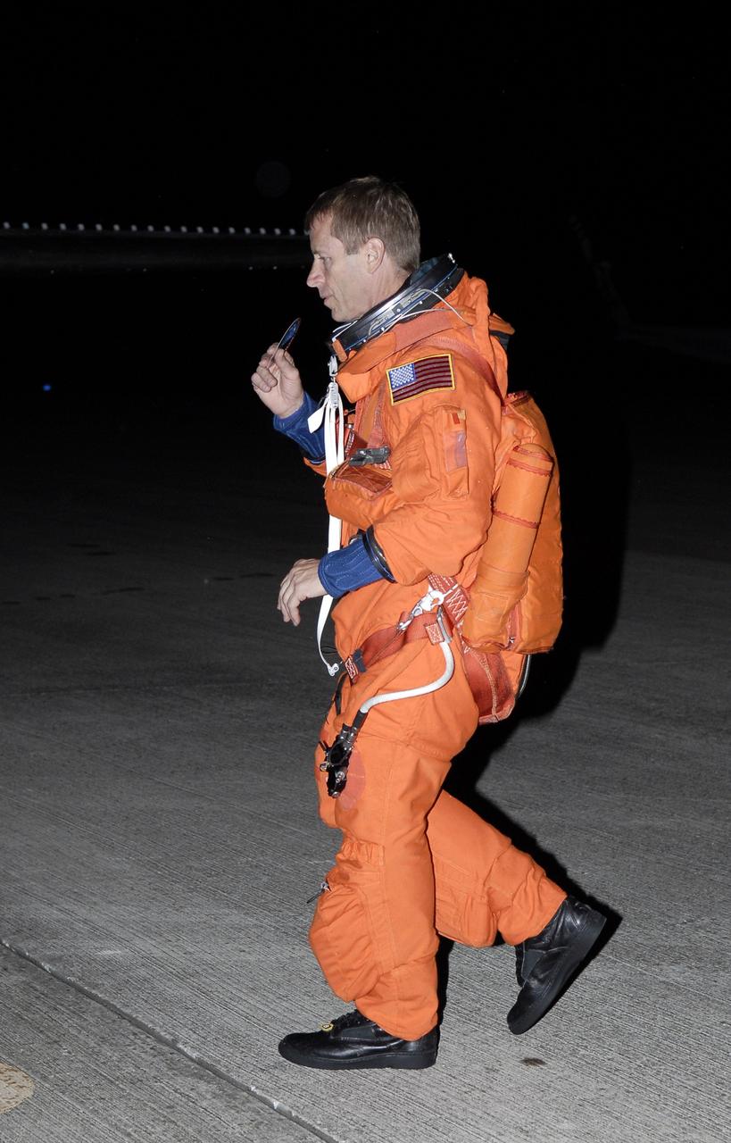 CAPE CANAVERAL, Fla. -  STS-125 Pilot Gregory C. Johnson walks toward the shuttle training aircraft on the Shuttle Landing Facility at NASA's Kennedy Space Center in Florida. He will practice shuttle landings on the runway. The STA is a Grumman American Aviation-built Gulf Stream II jet that was modified to simulate a shuttle’s cockpit, motion and visual cues, and handling qualities. In flight, the aircraft duplicates the shuttle’s atmospheric descent trajectory from approximately 35,000 feet altitude to landing on a runway. The practice is part of a terminal countdown demonstration test, or TCDT, to prepare for launch.  TCDT provides astronauts and ground crews with an opportunity to participate in various simulated countdown activities, including equipment familiarization, emergency training and a simulated launch countdown. Space shuttle Atlantis’ STS-125 mission to service NASA’s Hubble Space Telescope is targeted to launch Oct. 10.  Photo credit: NASA/Kim Shiflett