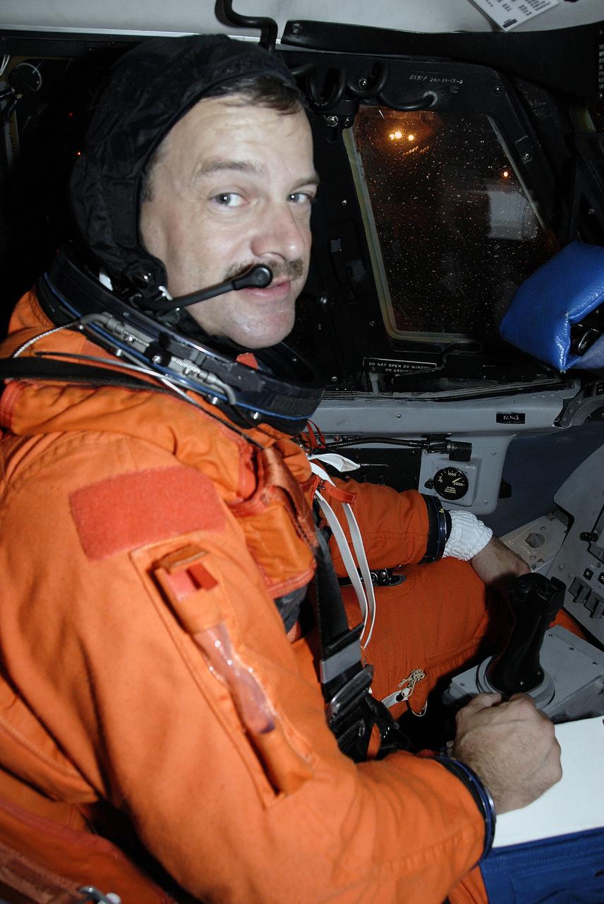 CAPE CANAVERAL, Fla. -  STS-125 Commander Scott Altman takes his seat in the shuttle training aircraft for practice shuttle landings on the runway of the Shuttle Landing Facility at NASA's Kennedy Space Center in Florida. The STA is a Grumman American Aviation-built Gulf Stream II jet that was modified to simulate a shuttle’s cockpit, motion and visual cues, and handling qualities. In flight, the aircraft duplicates the shuttle’s atmospheric descent trajectory from approximately 35,000 feet altitude to landing on a runway. The practice is part of a terminal countdown demonstration test, or TCDT, to prepare for launch.  TCDT provides astronauts and ground crews with an opportunity to participate in various simulated countdown activities, including equipment familiarization, emergency training and a simulated launch countdown. Space shuttle Atlantis’ STS-125 mission to service NASA’s Hubble Space Telescope is targeted to launch Oct. 10.  Photo credit: NASA/Kim Shiflett