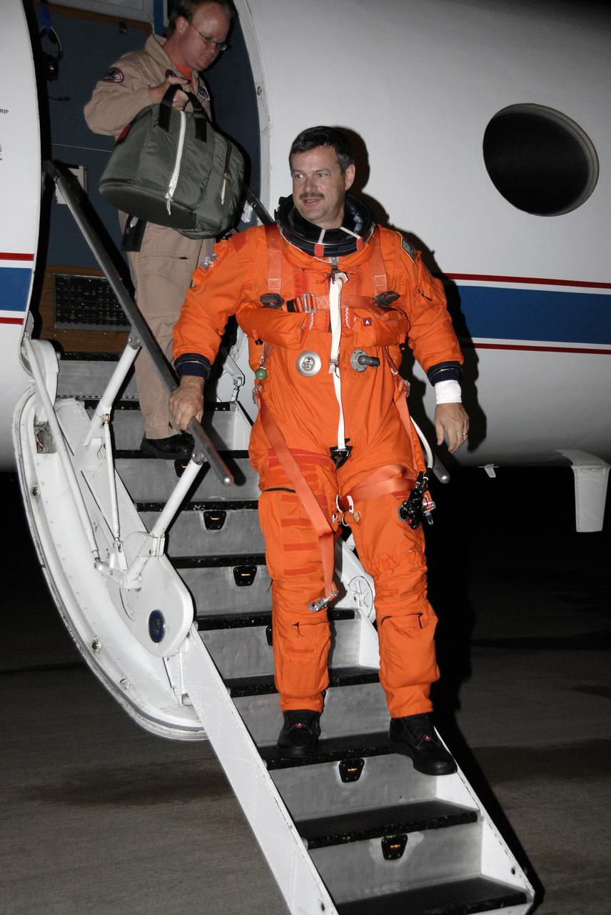 CAPE CANAVERAL, Fla. -  STS-125 Commander Scott Altman exits the shuttle training aircraft at the Shuttle Landing Facility at NASA's Kennedy Space Center in Florida after practicing shuttle landings in the aircraft.  The STA is a Grumman American Aviation-built Gulf Stream II jet that was modified to simulate a shuttle’s cockpit, motion and visual cues, and handling qualities. In flight, the aircraft duplicates the shuttle’s atmospheric descent trajectory from approximately 35,000 feet altitude to landing on a runway. The practice is part of a terminal countdown demonstration test, or TCDT, to prepare for launch.  TCDT provides astronauts and ground crews with an opportunity to participate in various simulated countdown activities, including equipment familiarization, emergency training and a simulated launch countdown. Space shuttle Atlantis’ STS-125 mission to service NASA’s Hubble Space Telescope is targeted to launch Oct. 10.  Photo credit: NASA/Kim Shiflett