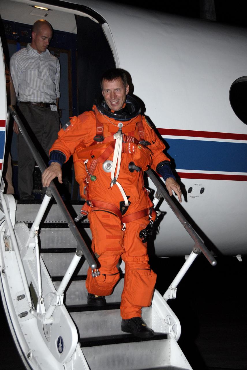 CAPE CANAVERAL, Fla. -   STS-125 Pilot Gregory C. Johnson exits the shuttle training aircraft at the Shuttle Landing Facility at NASA's Kennedy Space Center in Florida after practicing shuttle landings in the aircraft.  The STA is a Grumman American Aviation-built Gulf Stream II jet that was modified to simulate a shuttle’s cockpit, motion and visual cues, and handling qualities. In flight, the aircraft duplicates the shuttle’s atmospheric descent trajectory from approximately 35,000 feet altitude to landing on a runway. The practice is part of a terminal countdown demonstration test, or TCDT, to prepare for launch.  TCDT provides astronauts and ground crews with an opportunity to participate in various simulated countdown activities, including equipment familiarization, emergency training and a simulated launch countdown. Space shuttle Atlantis’ STS-125 mission to service NASA’s Hubble Space Telescope is targeted to launch Oct. 10.  Photo credit: NASA/Kim Shiflett