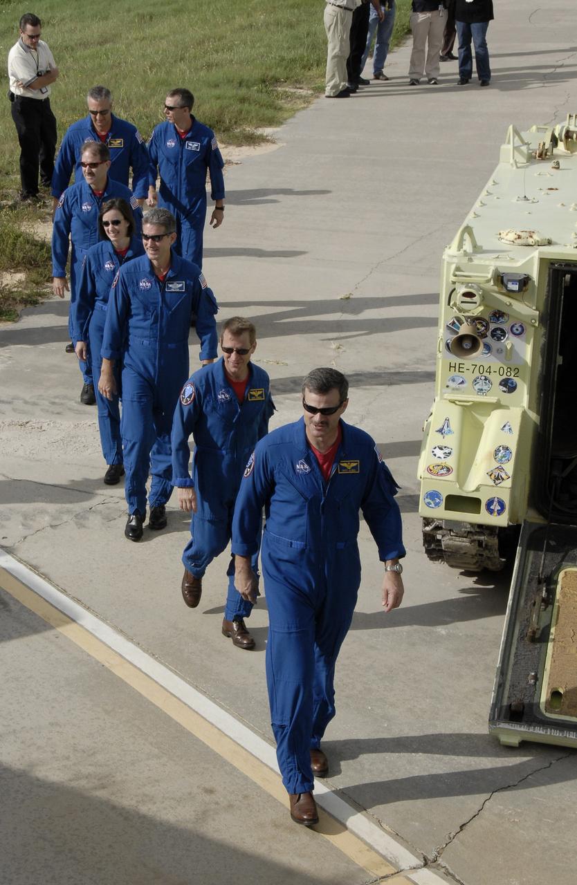 CAPE CANAVERAL, Fla. -  The STS-125 crew walks toward the emergency landing area on Launch Pad 39A at NASA's Kennedy Space Center in Florida to greet the media.  Leading the way, at right, is Commander Scott Altman.  Behind him, right to left, are Pilot Gregory C. Johnson and Mission Specialists Michael Good, Megan McArthur, John Grunsfeld, Mike Massimino and Andrew Feustel.  The crew is at Kennedy to take part in terminal countdown demonstration test, or TCDT, activities before launching on space shuttle Atlantis’ mission to service NASA’s Hubble Space Telescope. TCDT provides astronauts and ground crews with an opportunity to participate in various simulated countdown activities, including equipment familiarization, emergency training and a simulated launch countdown. Atlantis is targeted to launch Oct. 10. Photo credit: NASA/Kim Shiflett