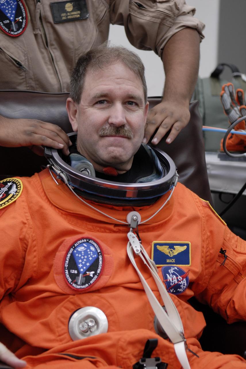 CAPE CANAVERAL, Fla. - STS-125 Mission Specialist John Grunsfeld tries on his launch-and-entry suit to check the fit. A veteran in space, Grunsfeld will be making his fifth shuttle launch. His name patch reflects the nicknames the crew gave each other. The crew is at NASA's Kennedy Space Center in Florida to take part in terminal countdown demonstration test, or TCDT, activities as preparation before launch on space shuttle Atlantis’ STS-125 mission to service NASA’s Hubble Space Telescope. TCDT provides astronauts and ground crews with an opportunity to participate in various simulated countdown activities, including equipment familiarization, emergency training and a launch countdown. Atlantis is targeted to launch Oct. 14. Photo credit: NASA/Kim Shiflett