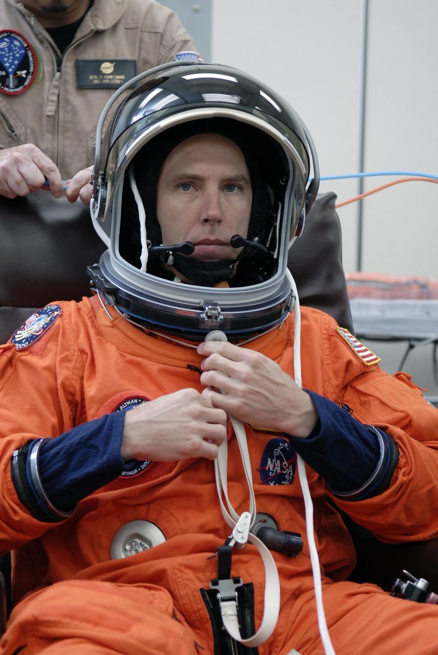 CAPE CANAVERAL, Fla. - STS-125 Mission Specialist Andrew Feustel tries on his helmet to check the fit. Feustel will be making his first shuttle launch. The crew is at NASA's Kennedy Space Center in Florida to take part in terminal countdown demonstration test, or TCDT, activities as preparation before launch on space shuttle Atlantis’ STS-125 mission to service NASA’s Hubble Space Telescope. TCDT provides astronauts and ground crews with an opportunity to participate in various simulated countdown activities, including equipment familiarization, emergency training and a launch countdown. Atlantis is targeted to launch Oct. 14. Photo credit: NASA/Kim Shiflett