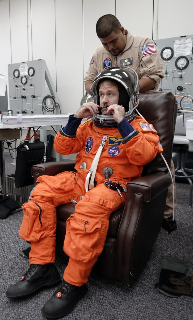 CAPE CANAVERAL, Fla. - STS-125 Mission Specialist John Grunsfeld tries on his helmet to check the fit. A veteran in space, Grunsfeld will be making his fifth shuttle launch. His name patch reflects the nicknames the crew gave each other. The crew is at NASA's Kennedy Space Center in Florida to take part in terminal countdown demonstration test, or TCDT, activities as preparation before launch on space shuttle Atlantis’ STS-125 mission to service NASA’s Hubble Space Telescope. TCDT provides astronauts and ground crews with an opportunity to participate in various simulated countdown activities, including equipment familiarization, emergency training and a launch countdown. Atlantis is targeted to launch Oct. 14. Photo credit: NASA/Kim Shiflett