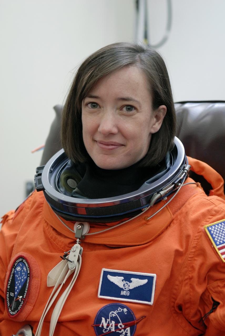 CAPE CANAVERAL, Fla. - STS-125 Mission Specialist Megan McArthur tries on her launch-and-entry suit to check the fit. McArthur will be making her first shuttle launch. Her name patch reflects the nicknames the crew gave each other. The crew is at NASA's Kennedy Space Center in Florida to take part in terminal countdown demonstration test, or TCDT, activities as preparation before launch on space shuttle Atlantis’ STS-125 mission to service NASA’s Hubble Space Telescope. TCDT provides astronauts and ground crews with an opportunity to participate in various simulated countdown activities, including equipment familiarization, emergency training and a launch countdown. Atlantis is targeted to launch Oct. 14. Photo credit: NASA/Kim Shiflett